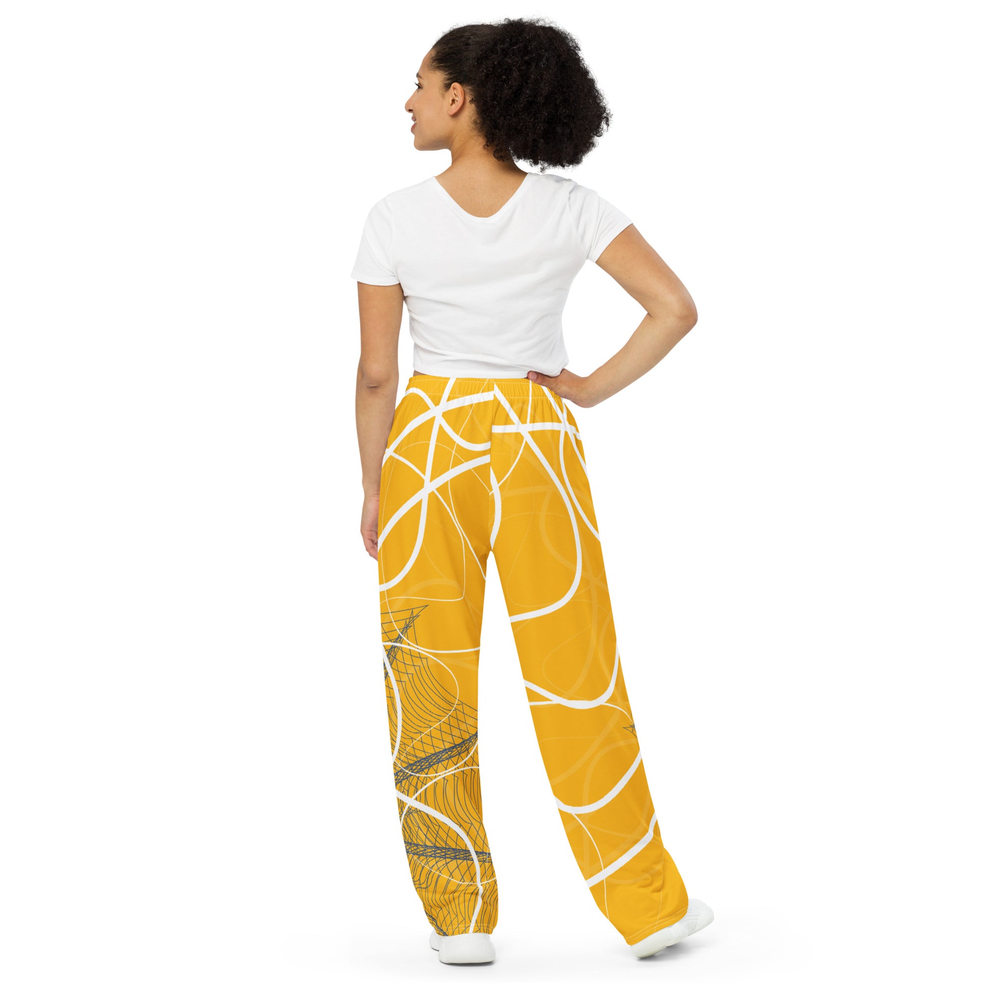 Golden yellow wide-leg pants featuring flowing white abstract line art and navy geometric patterns, merging expressive streetwear style with hand-drawn design from the Secret Chambers of I and I collection.