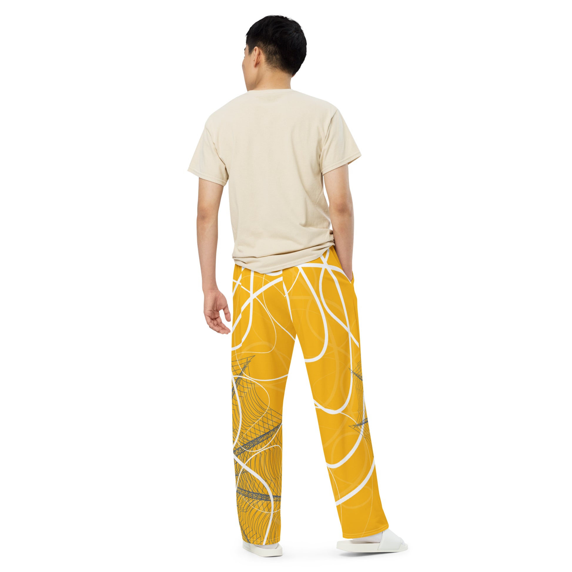 Golden yellow wide-leg pants featuring flowing white abstract line art and navy geometric patterns, merging expressive streetwear style with hand-drawn design from the Secret Chambers of I and I collection.