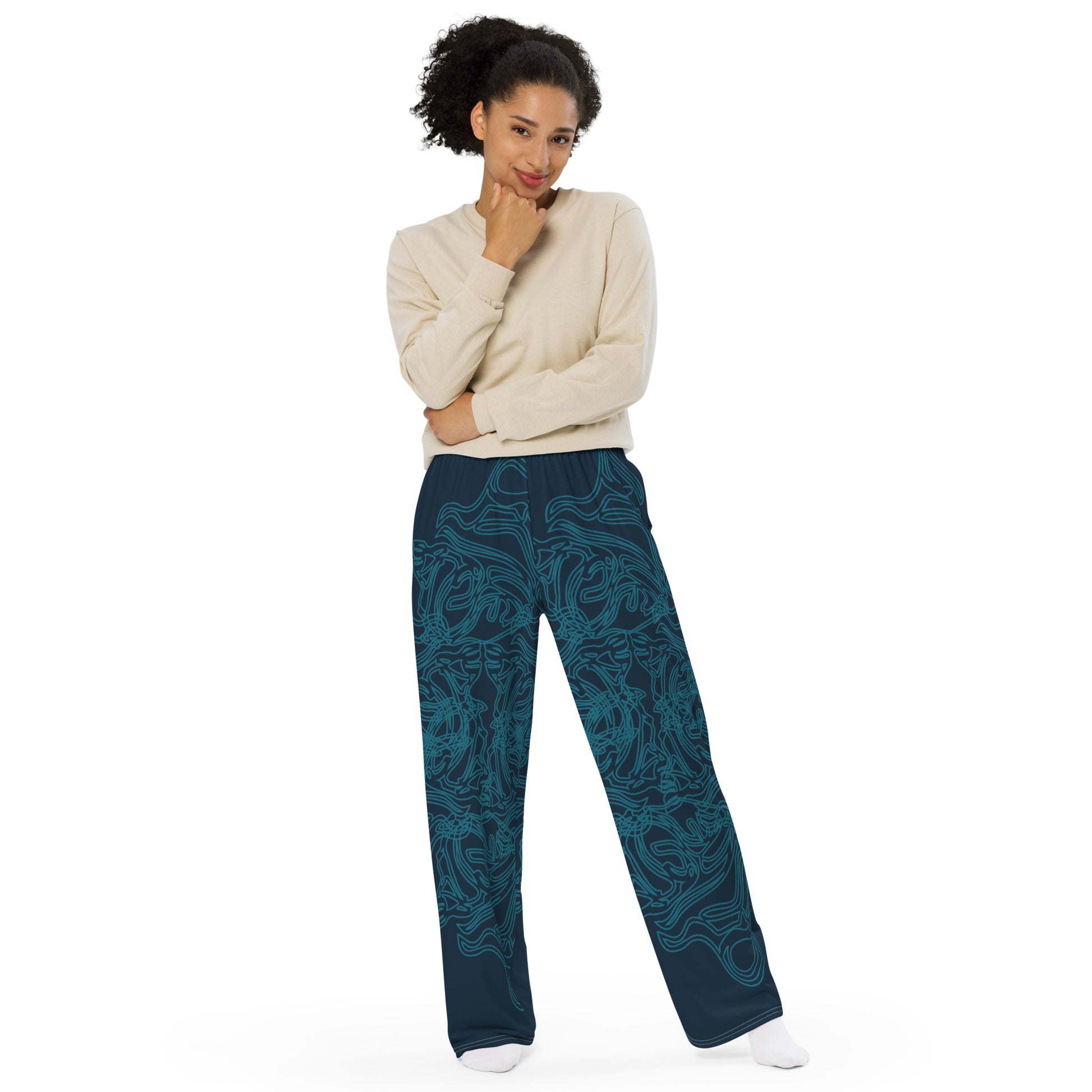 Navy blue wide-leg pants featuring intricate cyan linework, creating a fluid and artistic pattern for a bold statement look, on a model.
