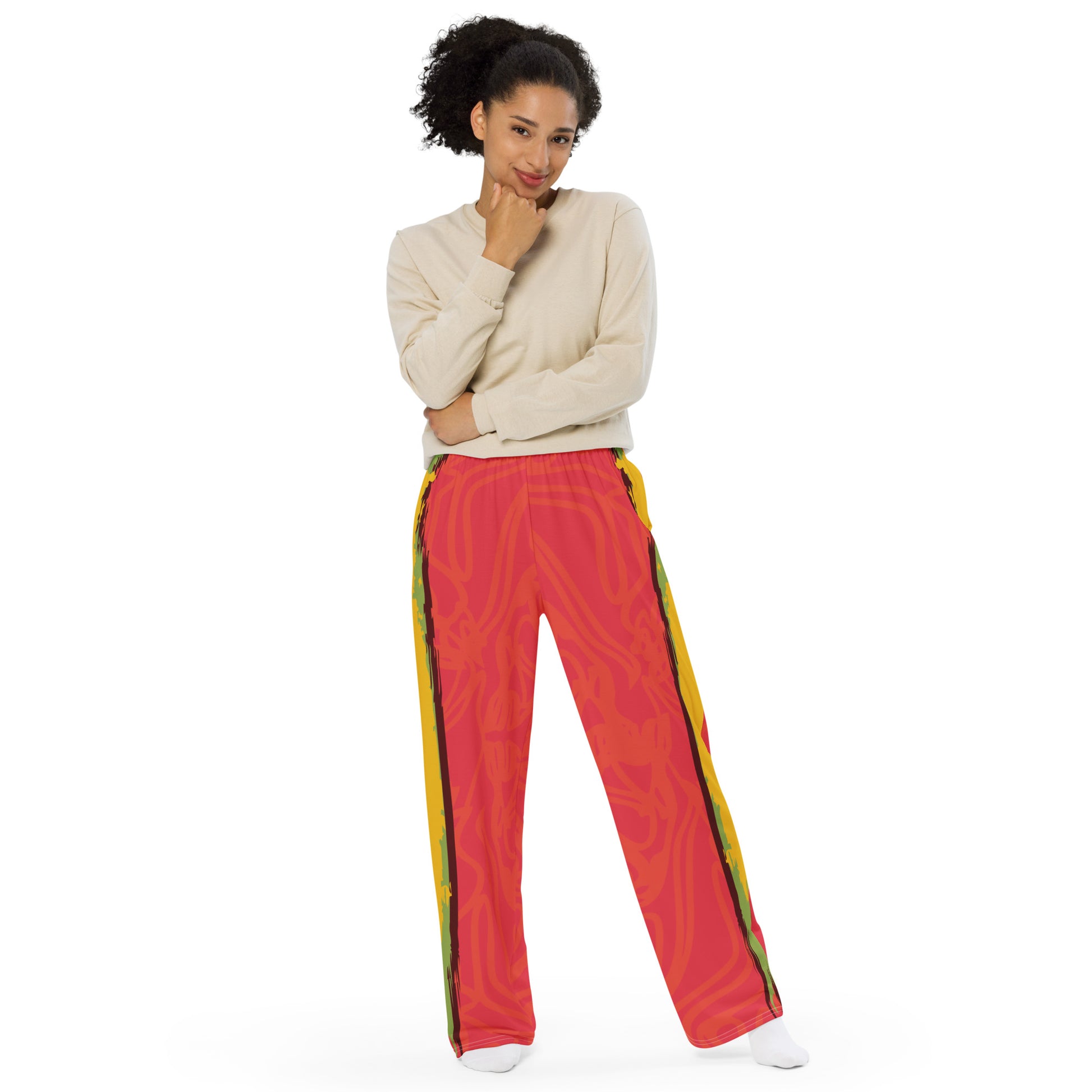 Wide-leg pants with a red base and abstract brushstroke side panels in yellow, green, and black, inspired by bold color play and cultural expression.