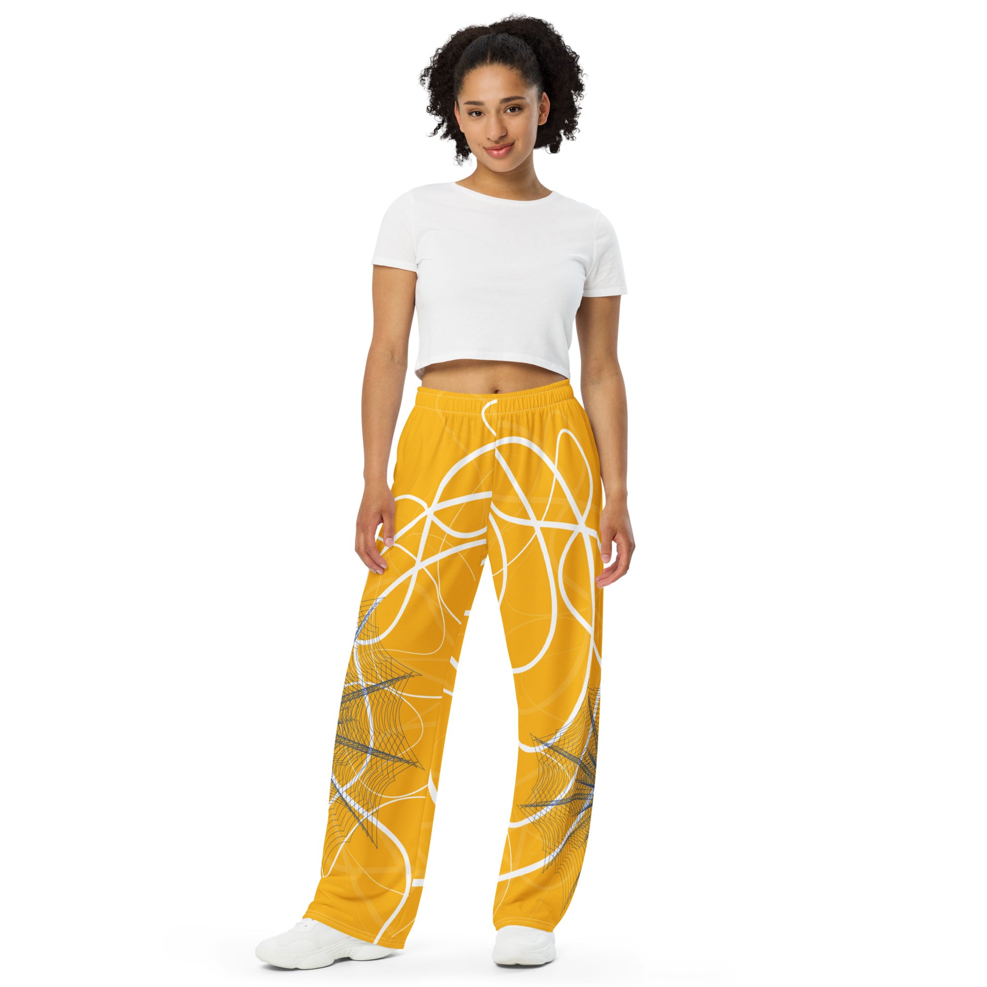 Golden yellow wide-leg pants featuring flowing white abstract line art and navy geometric patterns, merging expressive streetwear style with hand-drawn design from the Secret Chambers of I and I collection.
