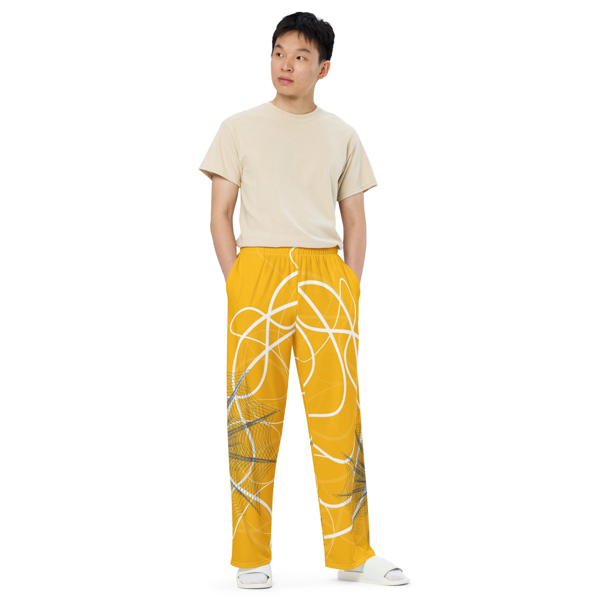 Golden yellow wide-leg pants featuring flowing white abstract line art and navy geometric patterns, merging expressive streetwear style with hand-drawn design from the Secret Chambers of I and I collection.