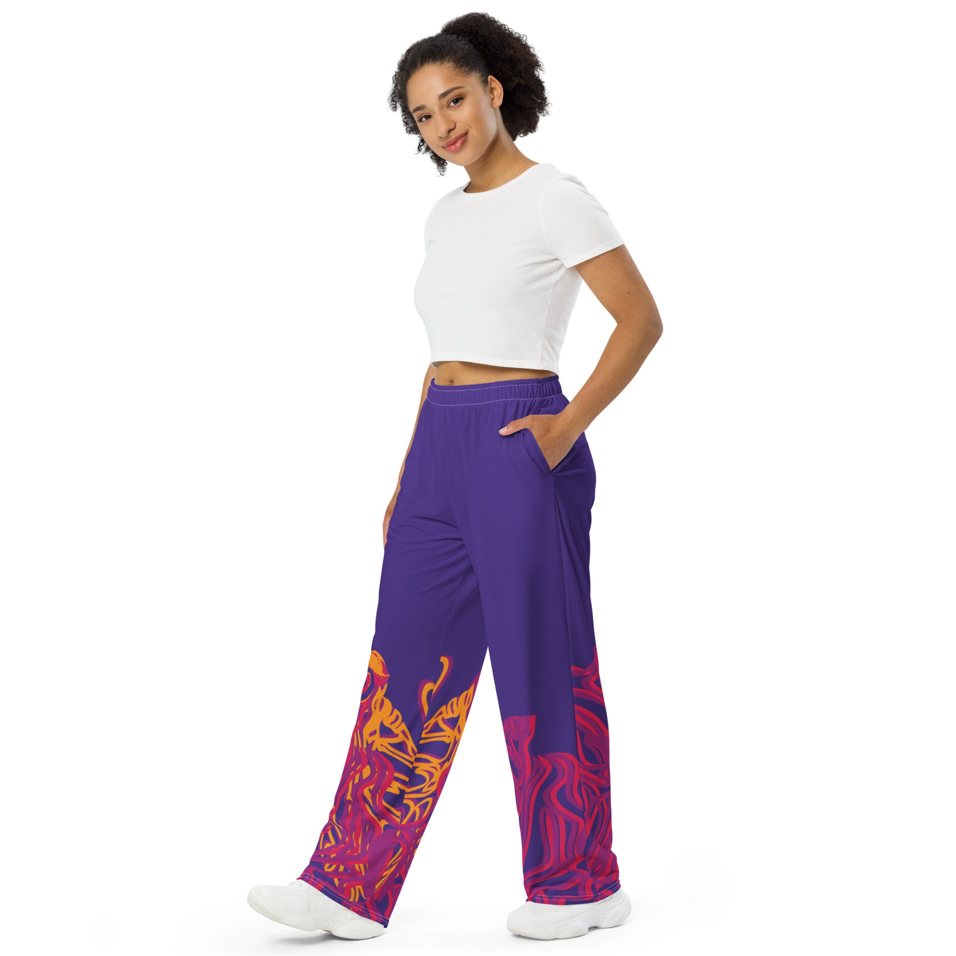 Bold purple wide-leg pants with vibrant orange and red culturally inspired patterns, featuring abstract swirling designs — expressive fashion from KLOE’s The Secret Chambers of I & I collection, on a model.