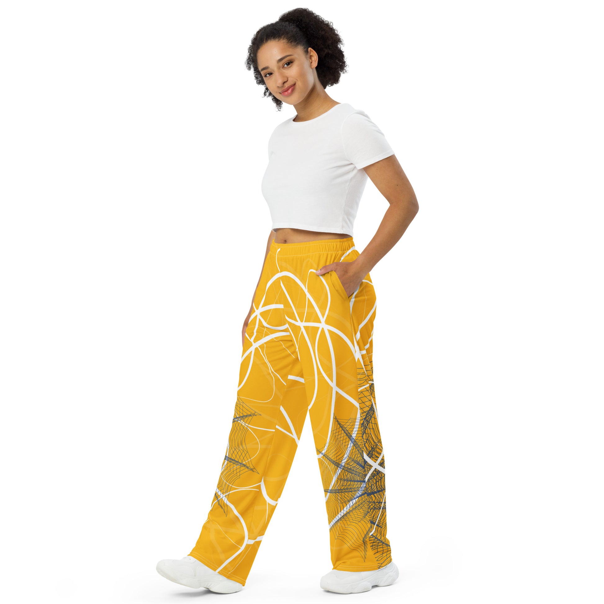 Golden yellow wide-leg pants featuring flowing white abstract line art and navy geometric patterns, merging expressive streetwear style with hand-drawn design from the Secret Chambers of I and I collection.
