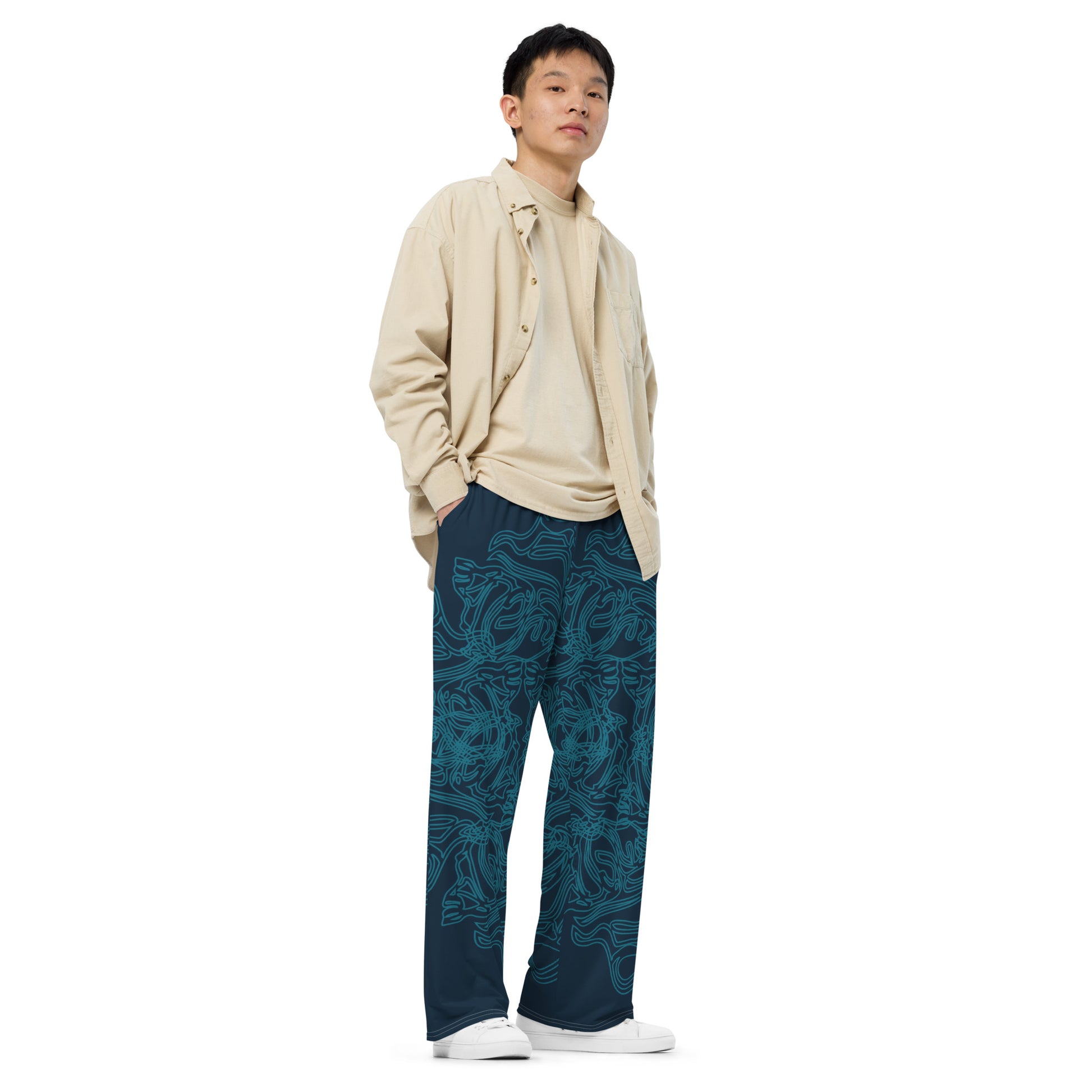 Navy blue wide-leg pants featuring intricate cyan linework, creating a fluid and artistic pattern for a bold statement look, on a model.