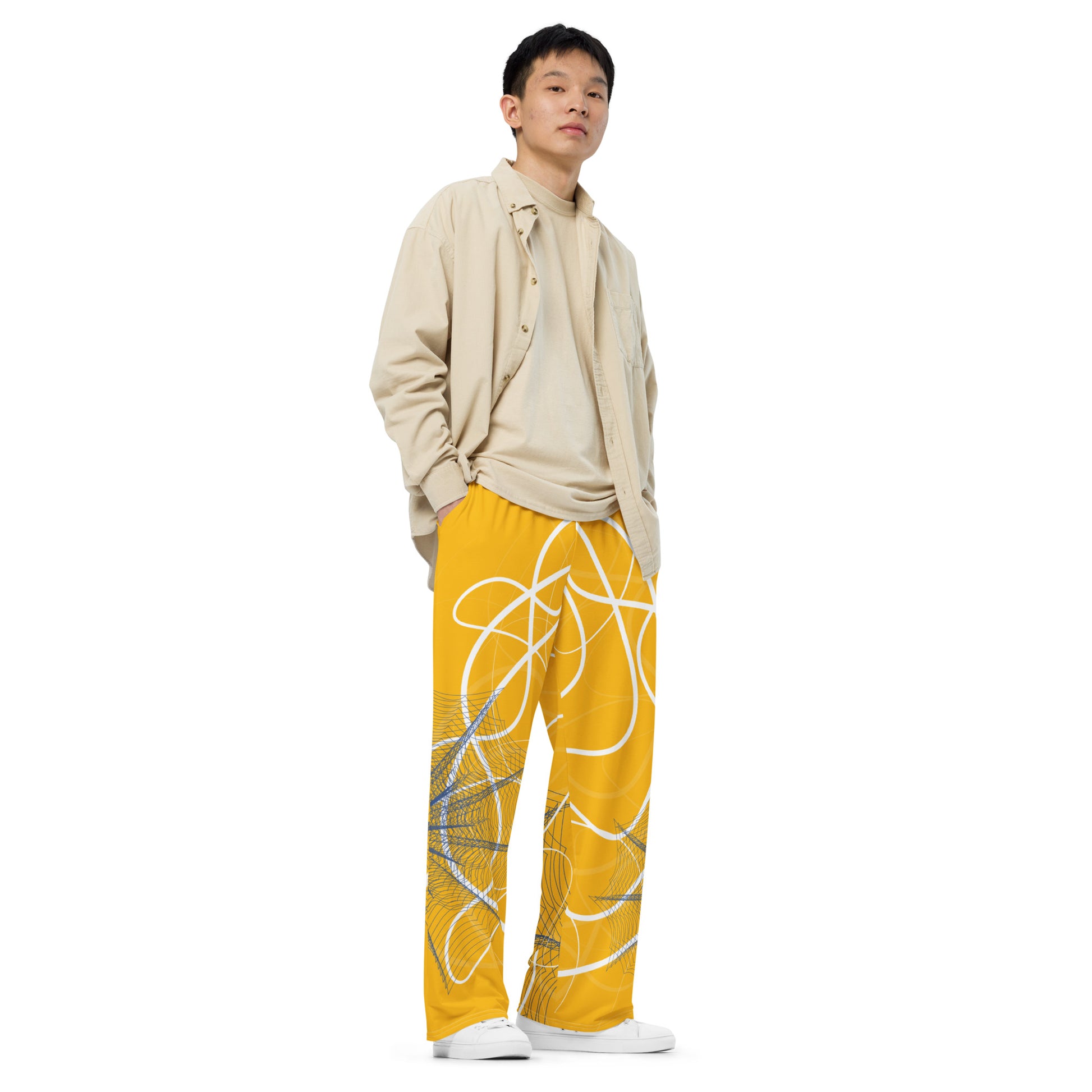Golden yellow wide-leg pants featuring flowing white abstract line art and navy geometric patterns, merging expressive streetwear style with hand-drawn design from the Secret Chambers of I and I collection.