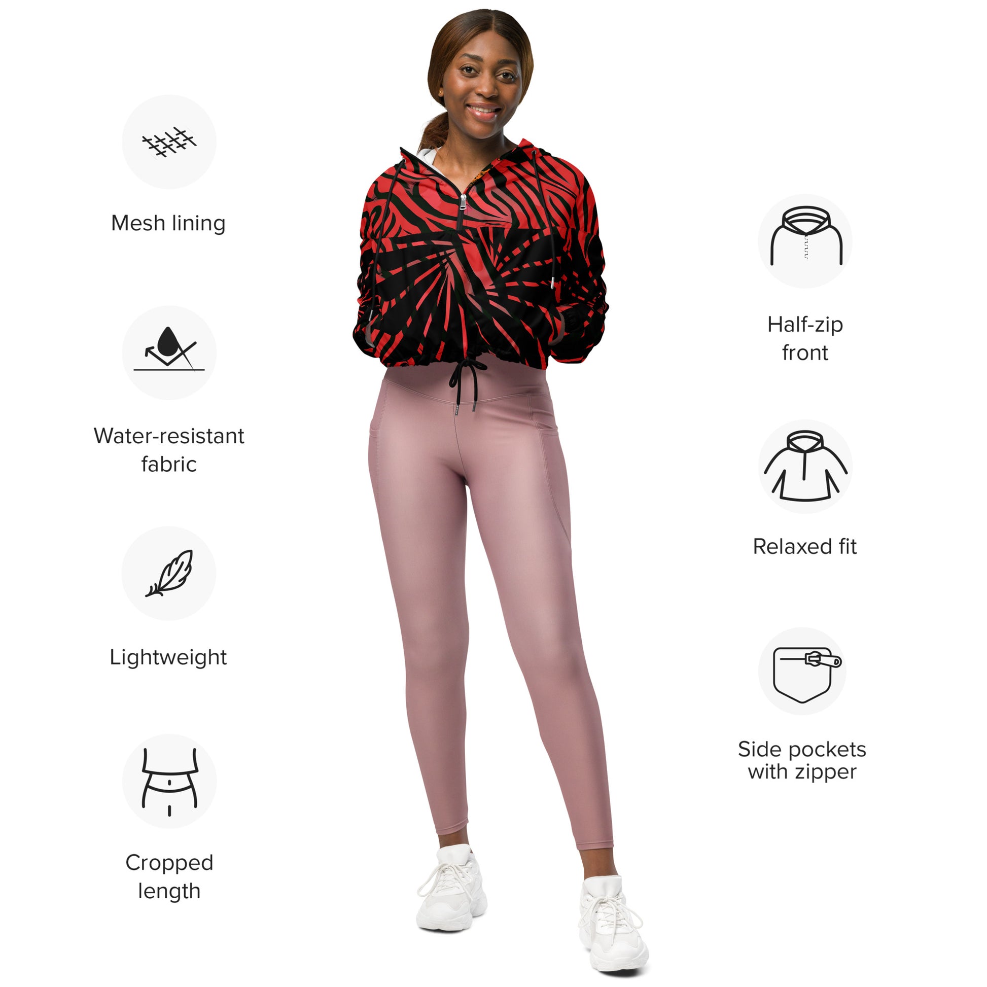 The model wearing red and black cropped women's windbreaker from Kloe Store featuring a bold swirling pattern, adjustable drawstring hem, and hood, showcasing trendy and stylish outerwear for modern street fashion, product specifications.