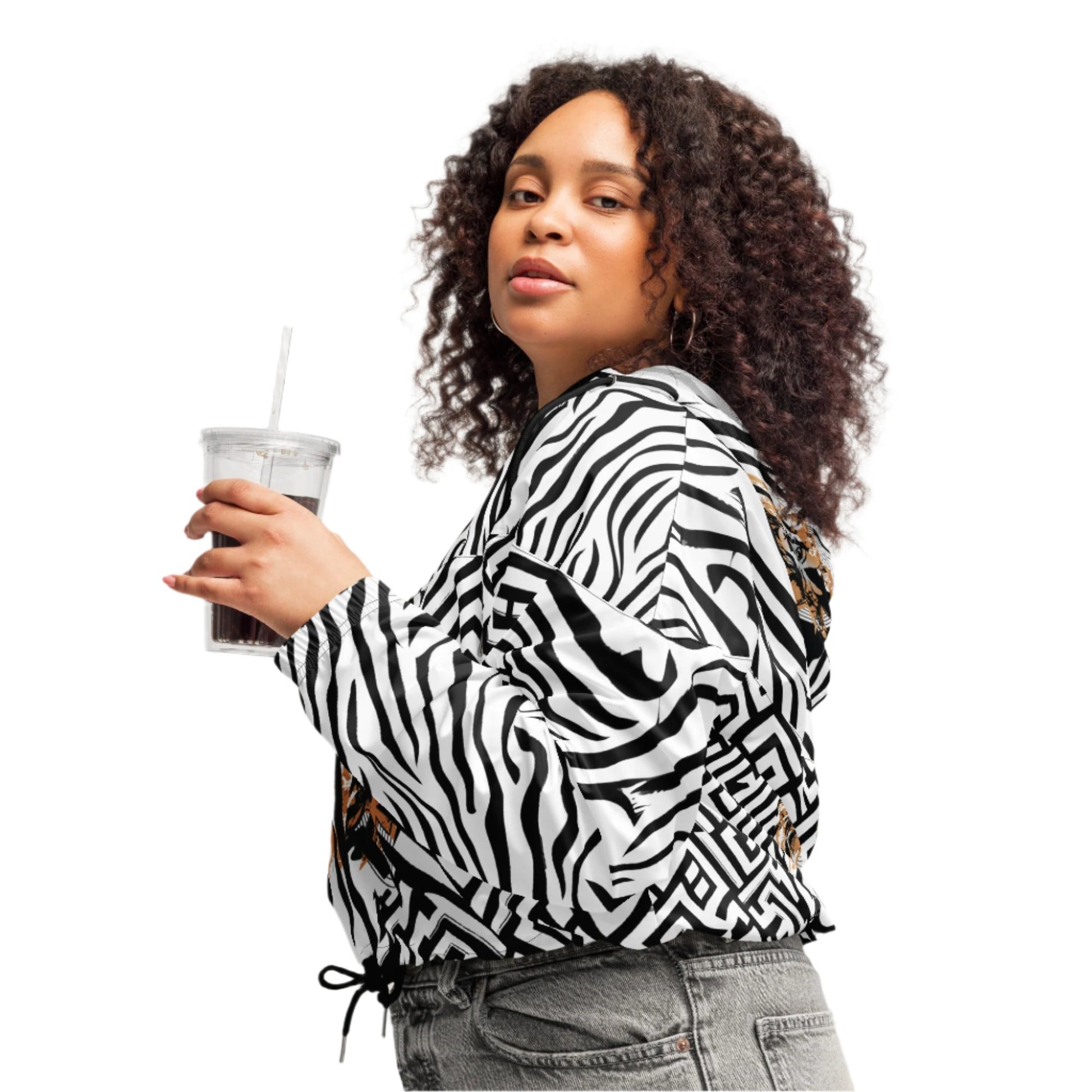 The model wearing black and white zebra print cropped windbreaker from Kloe Store featuring bold geometric patterns and an artistic face design, perfect for trendy streetwear fashion with an edgy, modern look.