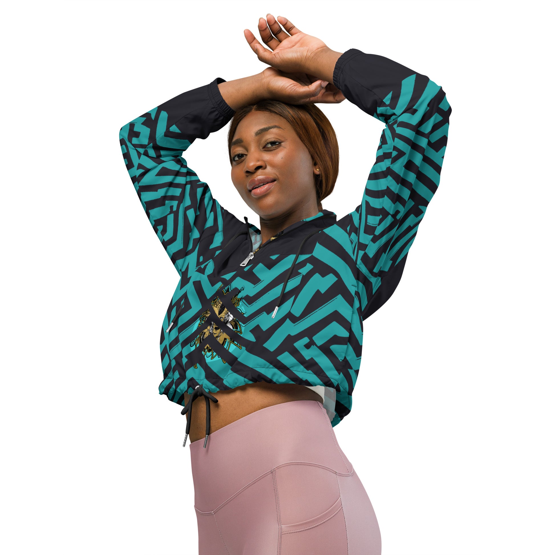 Confident woman wearing Kloe Store cropped windbreaker with bold green and black geometric patterns.