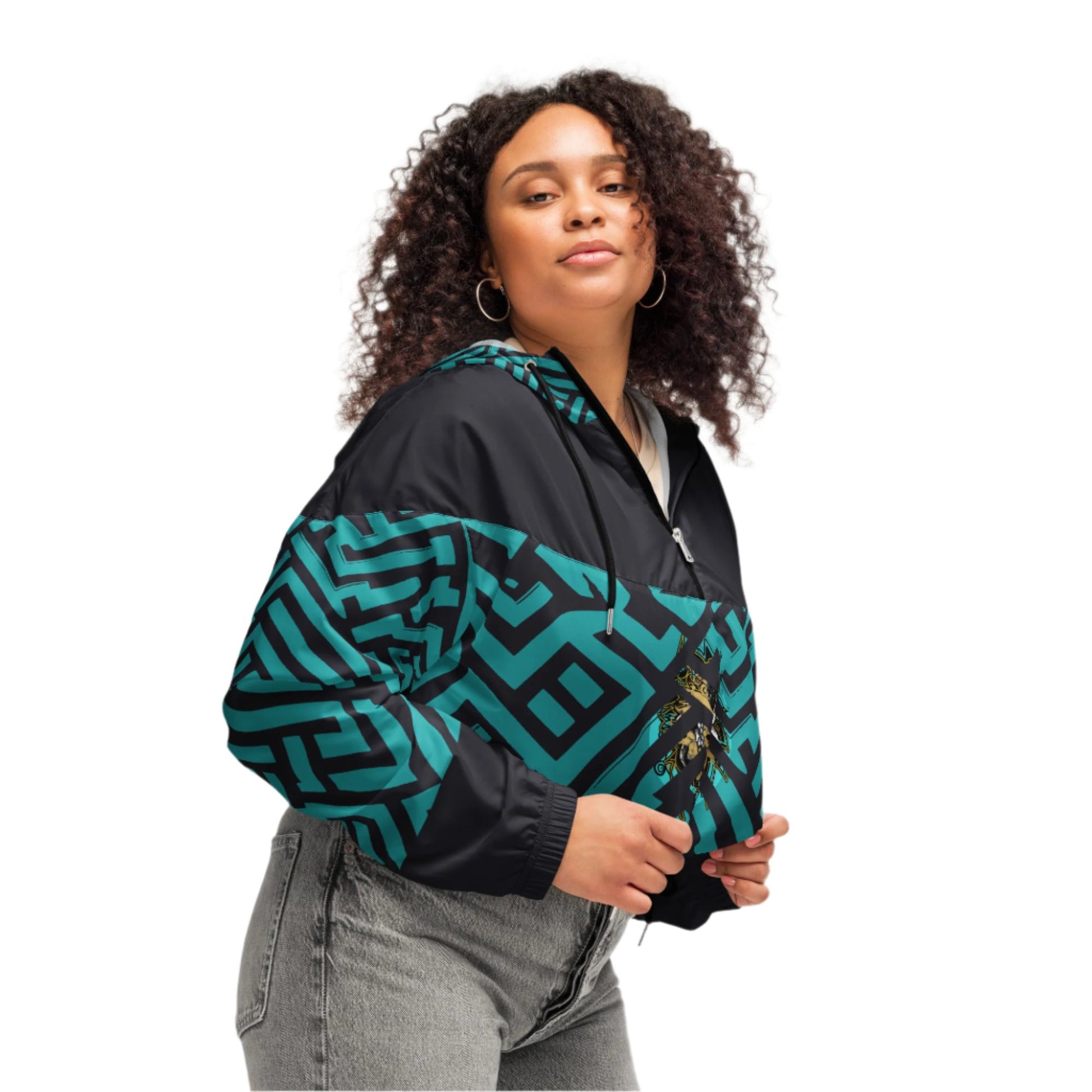Confident woman wearing Kloe Store cropped windbreaker with bold green and black geometric patterns.