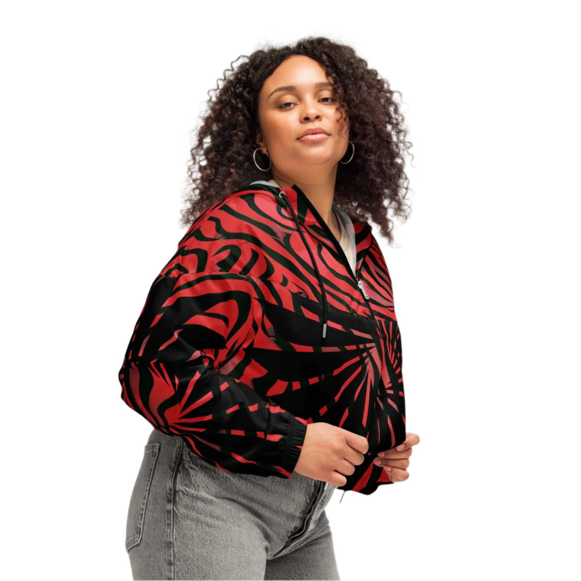 A model wearing Red and black cropped women's windbreaker from Kloe Store featuring a bold swirling pattern, adjustable drawstring hem, and hood, showcasing trendy and stylish outerwear for modern street fashion.