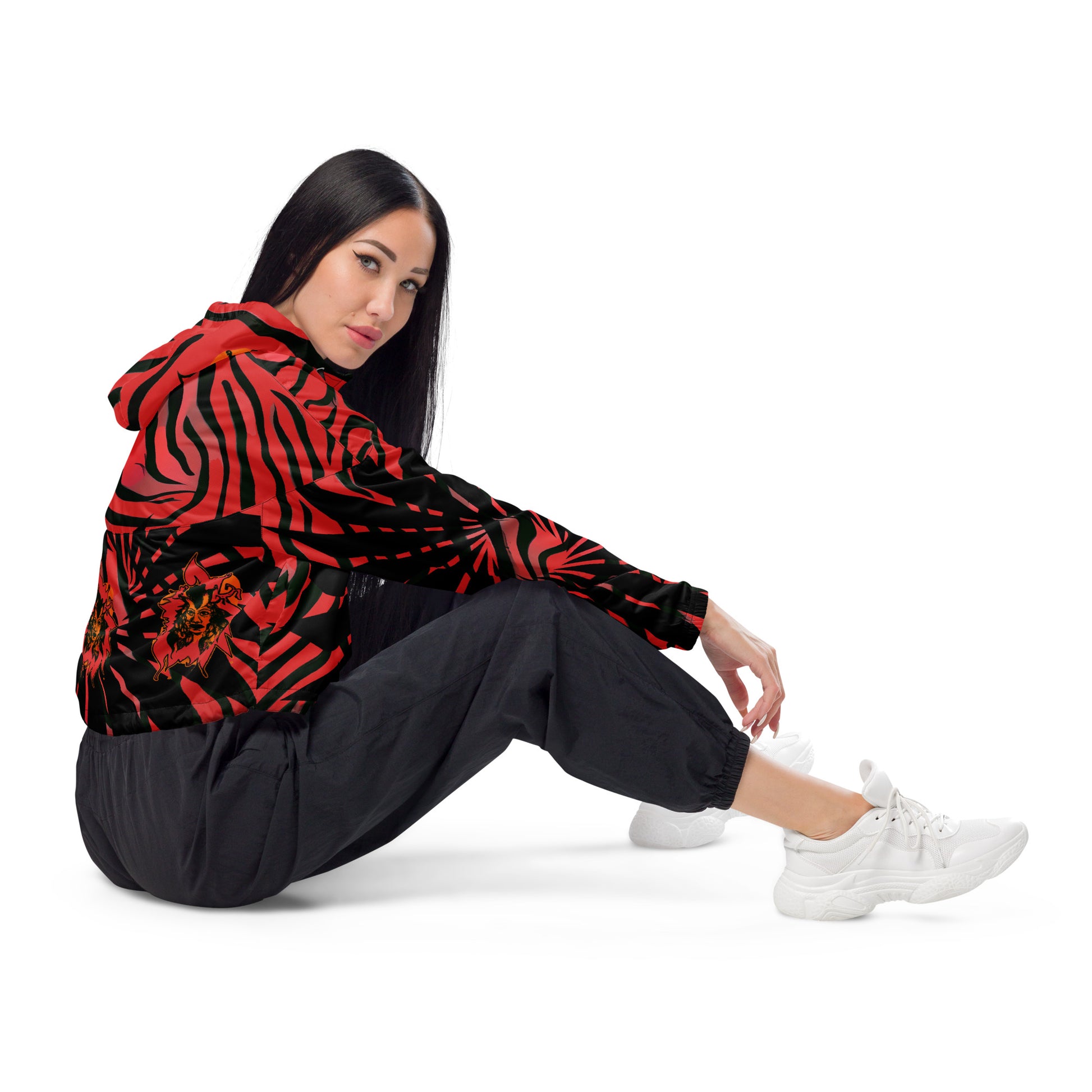 The model wearing red and black cropped women's windbreaker from Kloe Store featuring a bold swirling pattern, adjustable drawstring hem, and hood, showcasing trendy and stylish outerwear for modern street fashion.