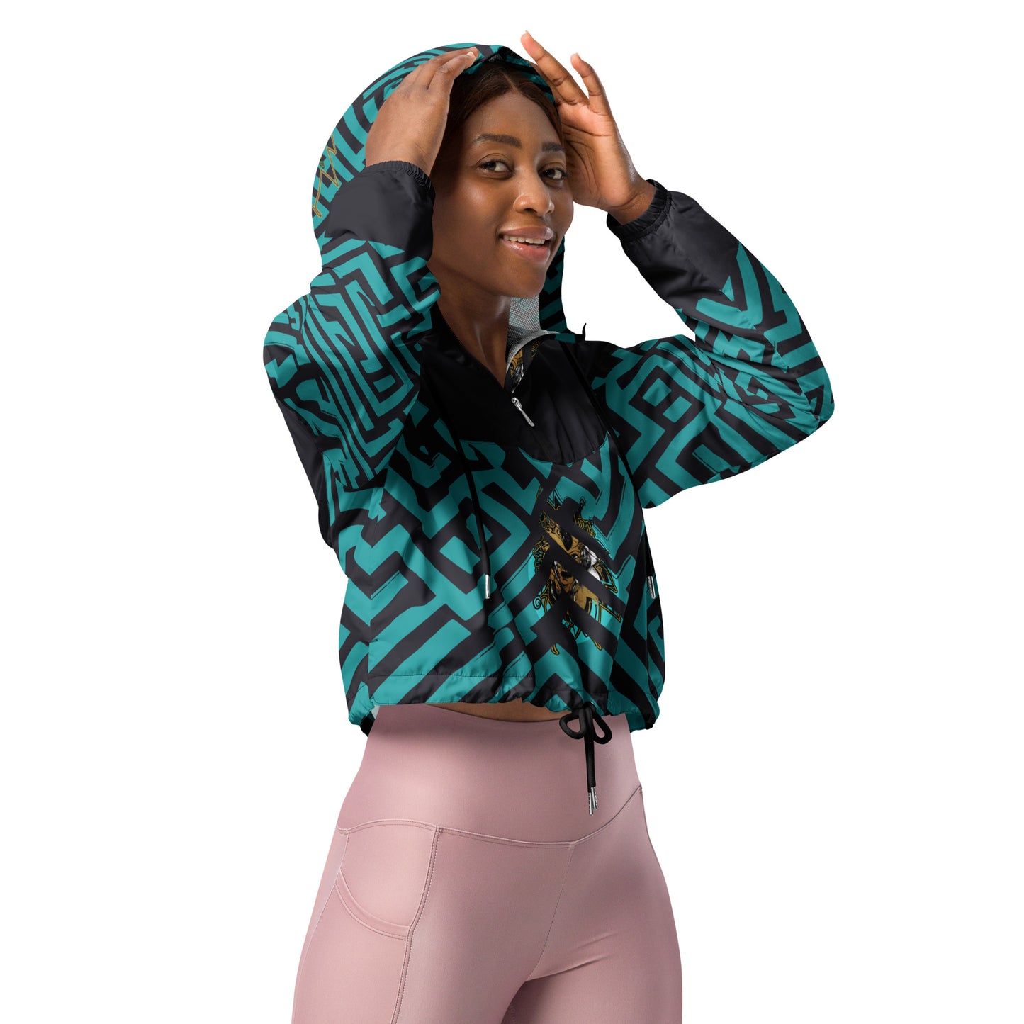 Confident woman wearing Kloe Store cropped windbreaker with bold green and black geometric patterns.
