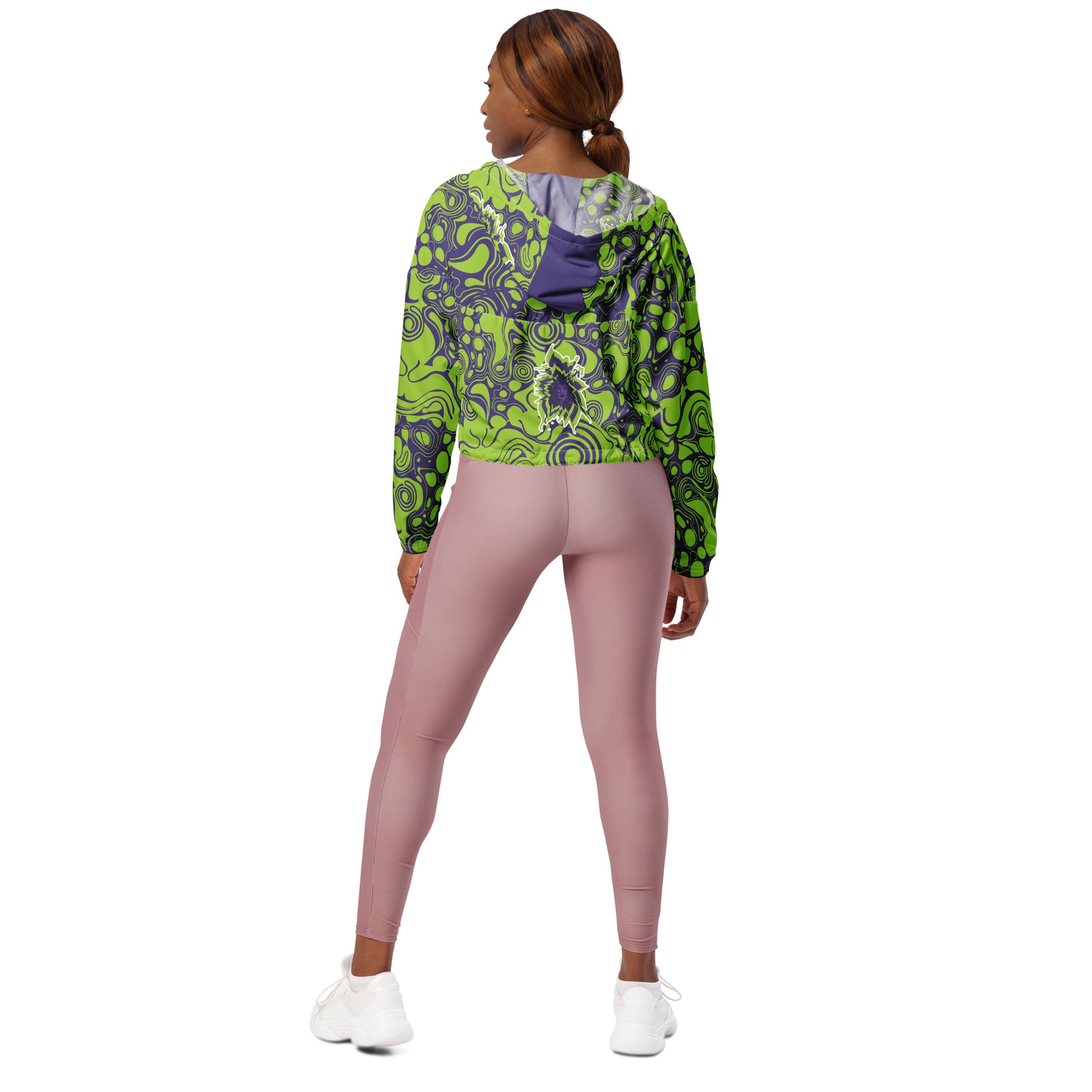 The model wearing green and purple cropped windbreaker from Kloe Store featuring bold abstract patterns and a unique artistic face design, ideal for a trendy streetwear look.