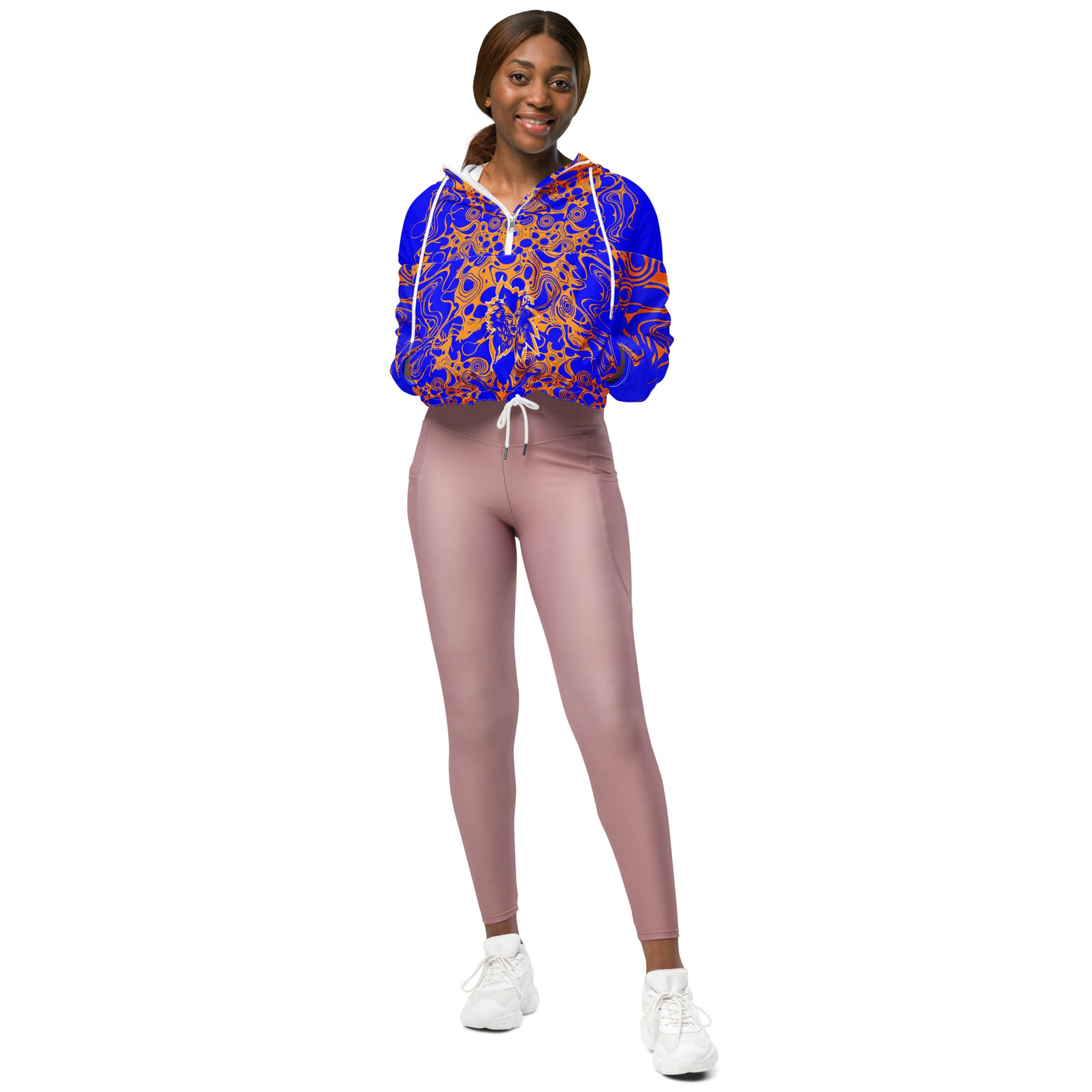Product mockup - model wearing a vibrant blue and orange cropped windbreaker from Kloe Store featuring abstract swirl pattern, a front zipper, drawstring hood, and elastic cuffs, offering a stylish and modern streetwear look.