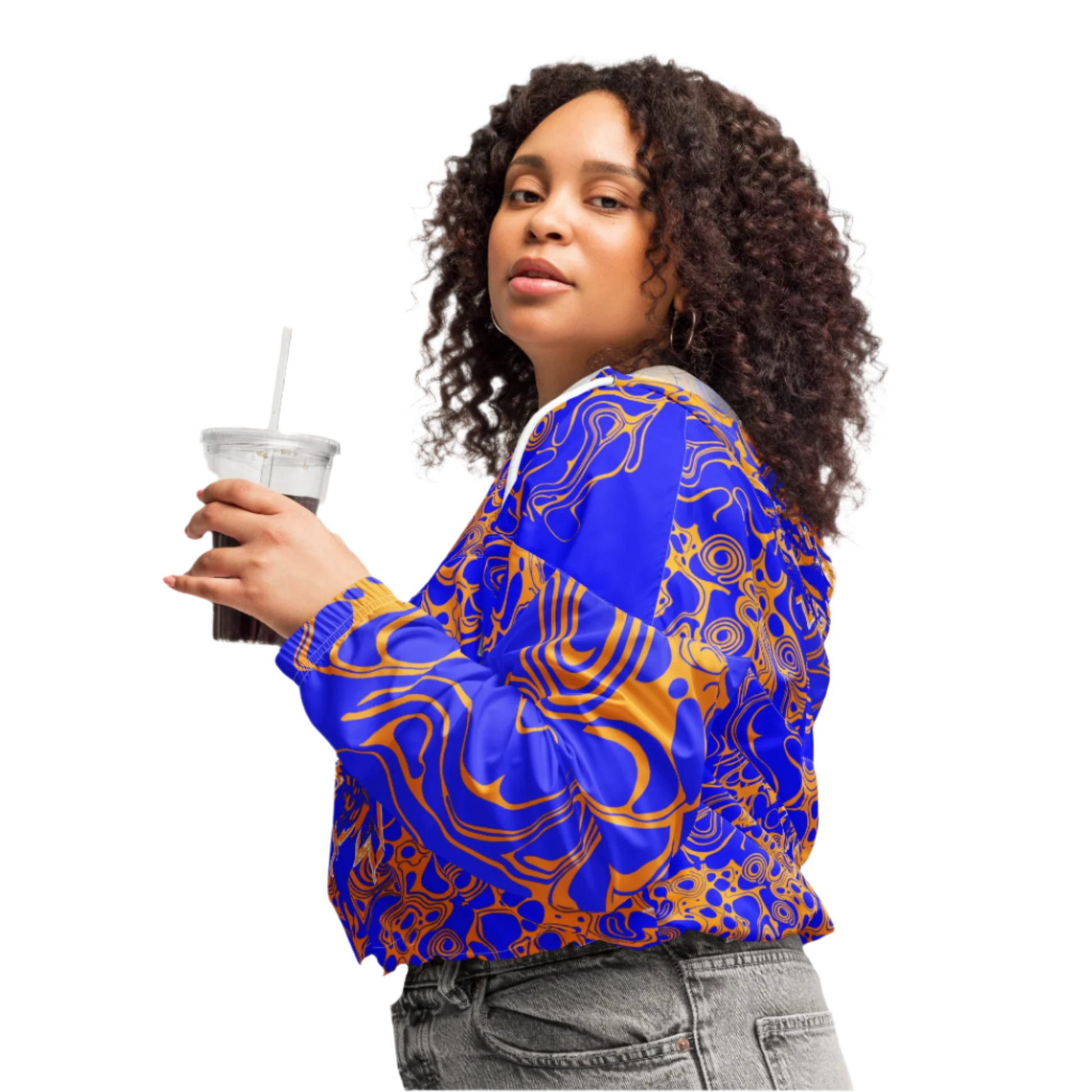 Product mockup - a model wearing vibrant blue and orange cropped windbreaker from Kloe Store featuring abstract swirl pattern, a front zipper, drawstring hood, and elastic cuffs, offering a stylish and modern streetwear look.