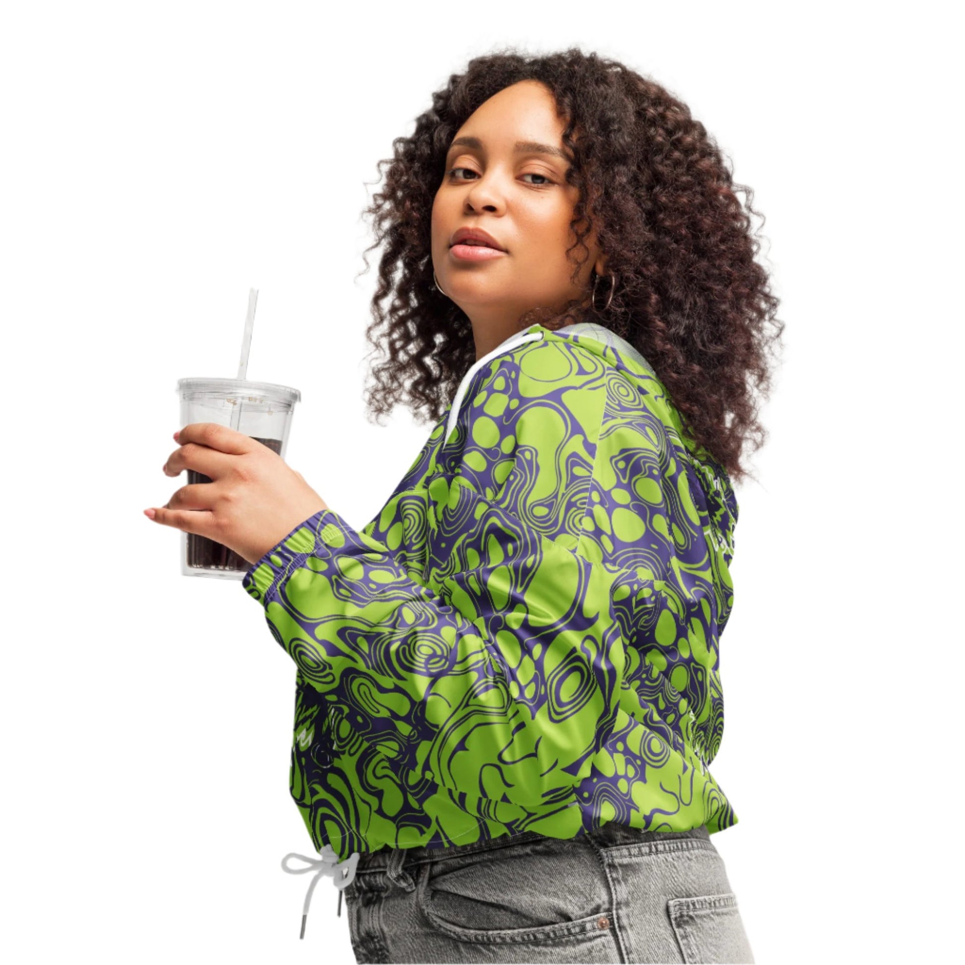 The model wearing green and purple cropped windbreaker from Kloe Store featuring bold abstract patterns and a unique artistic face design, ideal for a trendy streetwear look.