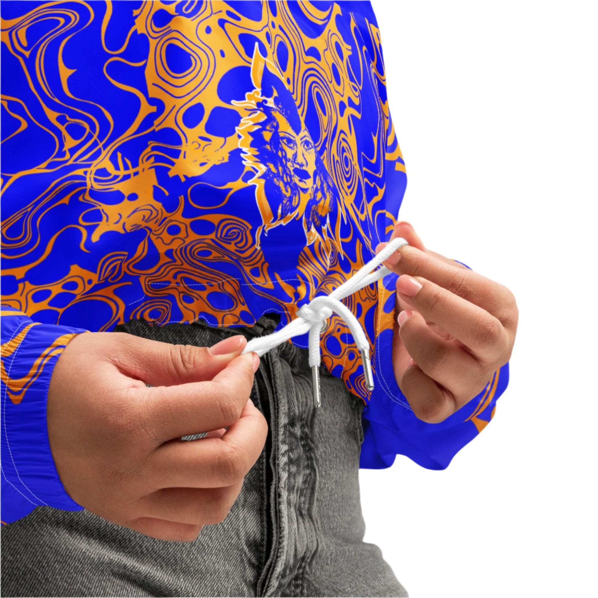 Product mockup - model wearing a vibrant blue and orange cropped windbreaker from Kloe Store featuring abstract swirl pattern, a front zipper, drawstring hood, and elastic cuffs, offering a stylish and modern streetwear look.