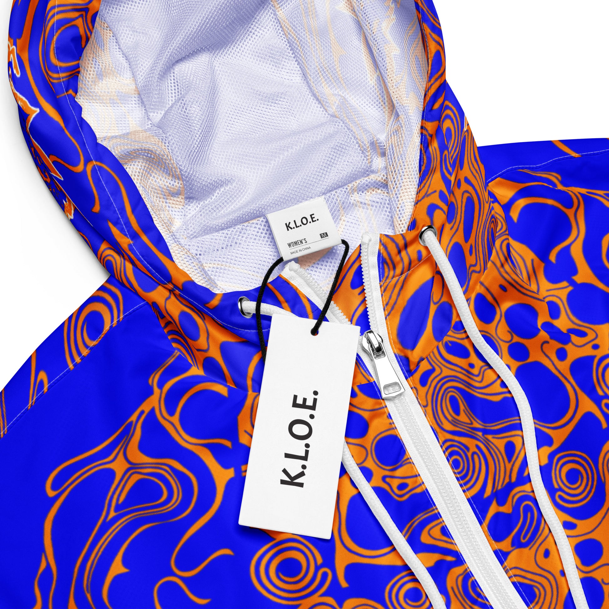 Vibrant blue and orange cropped windbreaker from Kloe Store featuring abstract swirl pattern, a front zipper, drawstring hood, and elastic cuffs, offering a stylish and modern streetwear look.