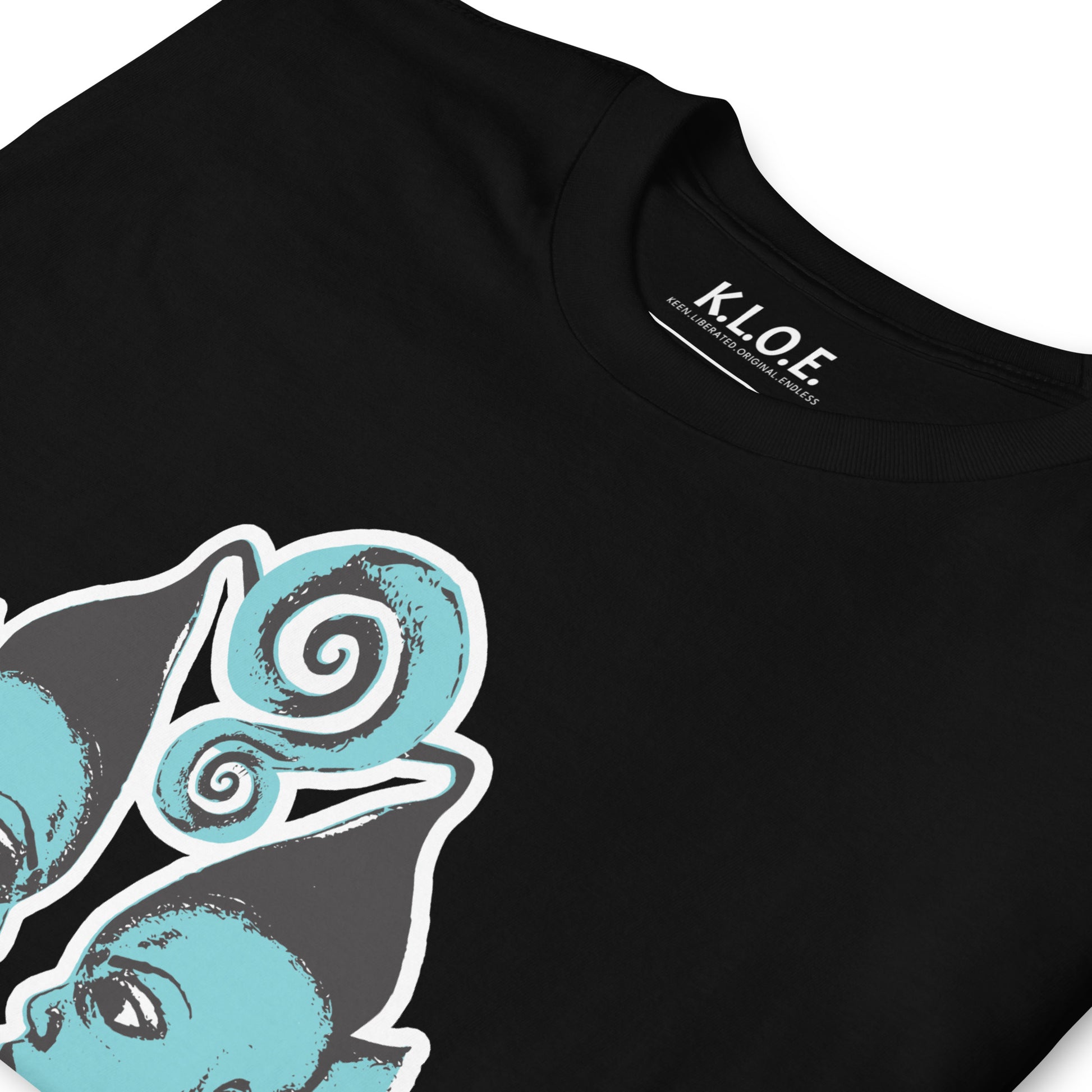 A model wearing black K.L.O.E. t-shirt showcasing a hand-drawn design of two mirrored faces in black and teal, embodying culturally inspired, bohemian style fashion focused on individuality and artistic expression, detail view showing the inside label.
