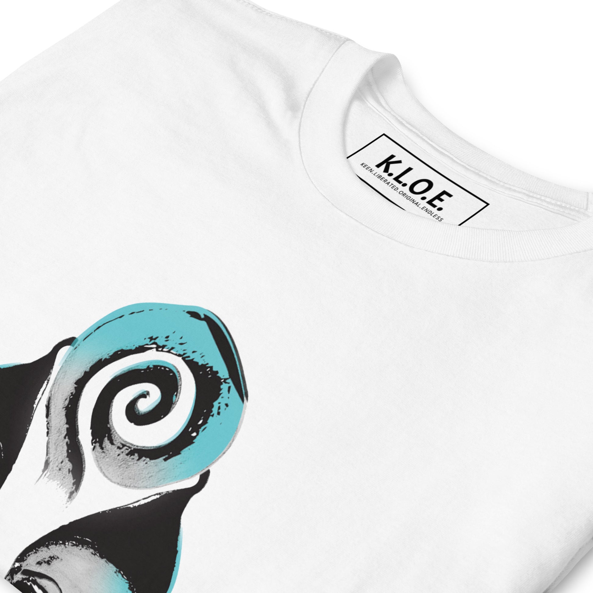 A detailed view of white K.L.O.E. t-shirt featuring a culturally inspired, hand-drawn design of two mirrored faces with bold, artistic details in black and teal, symbolizing self-expression and individuality in bohemian style clothing, inside label view.