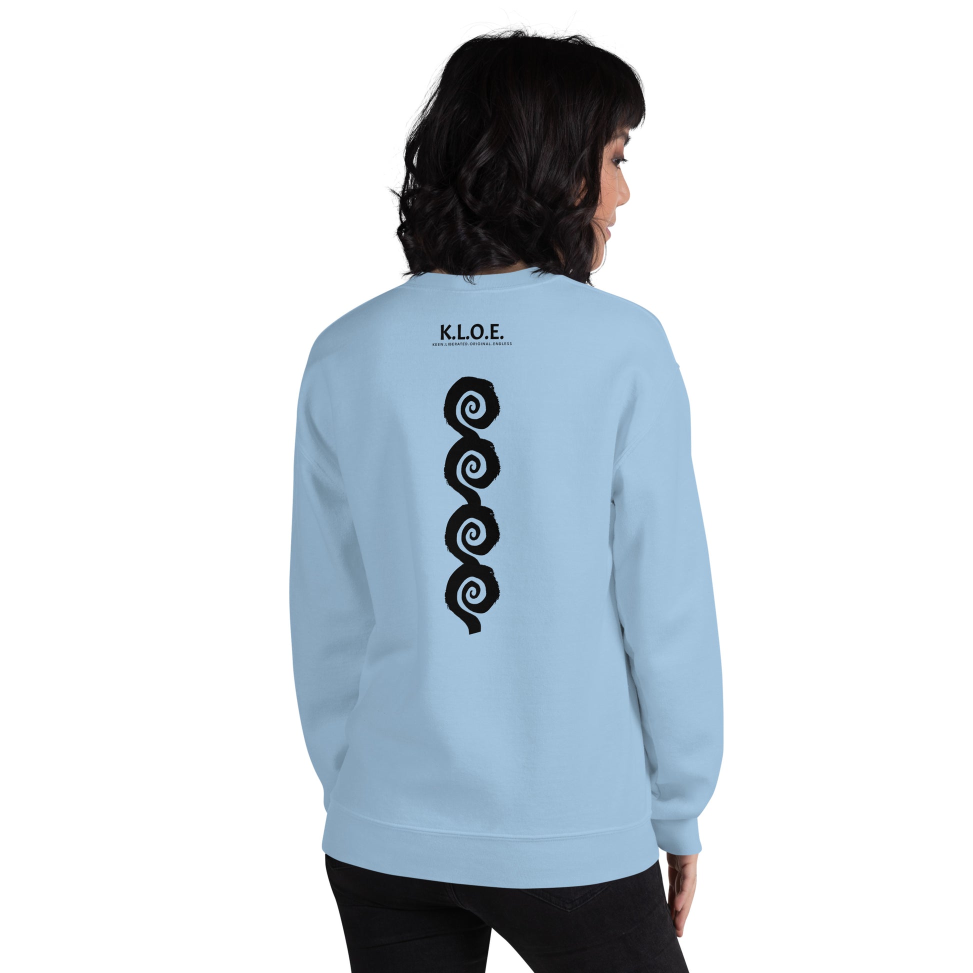 Back view of blue K.L.O.E. sweatshirt showcasing a bold, hand-drawn black spiral design symbolising creativity and individuality, with the K.L.O.E. logo above, reflecting modern bohemian style and artistic self-expression, worn by a model.
