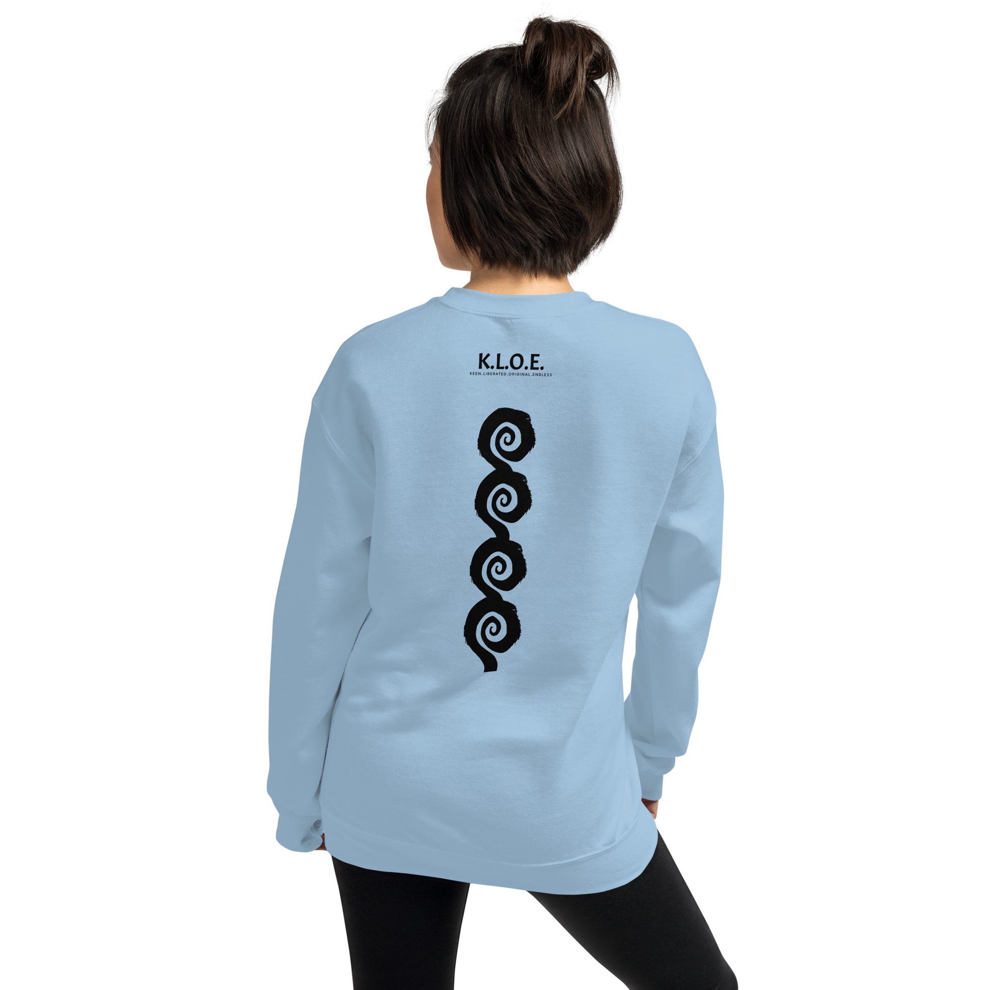 Back view of blue K.L.O.E. sweatshirt showcasing a bold, hand-drawn black spiral design symbolising creativity and individuality, with the K.L.O.E. logo above, reflecting modern bohemian style and artistic self-expression, worn by a model.