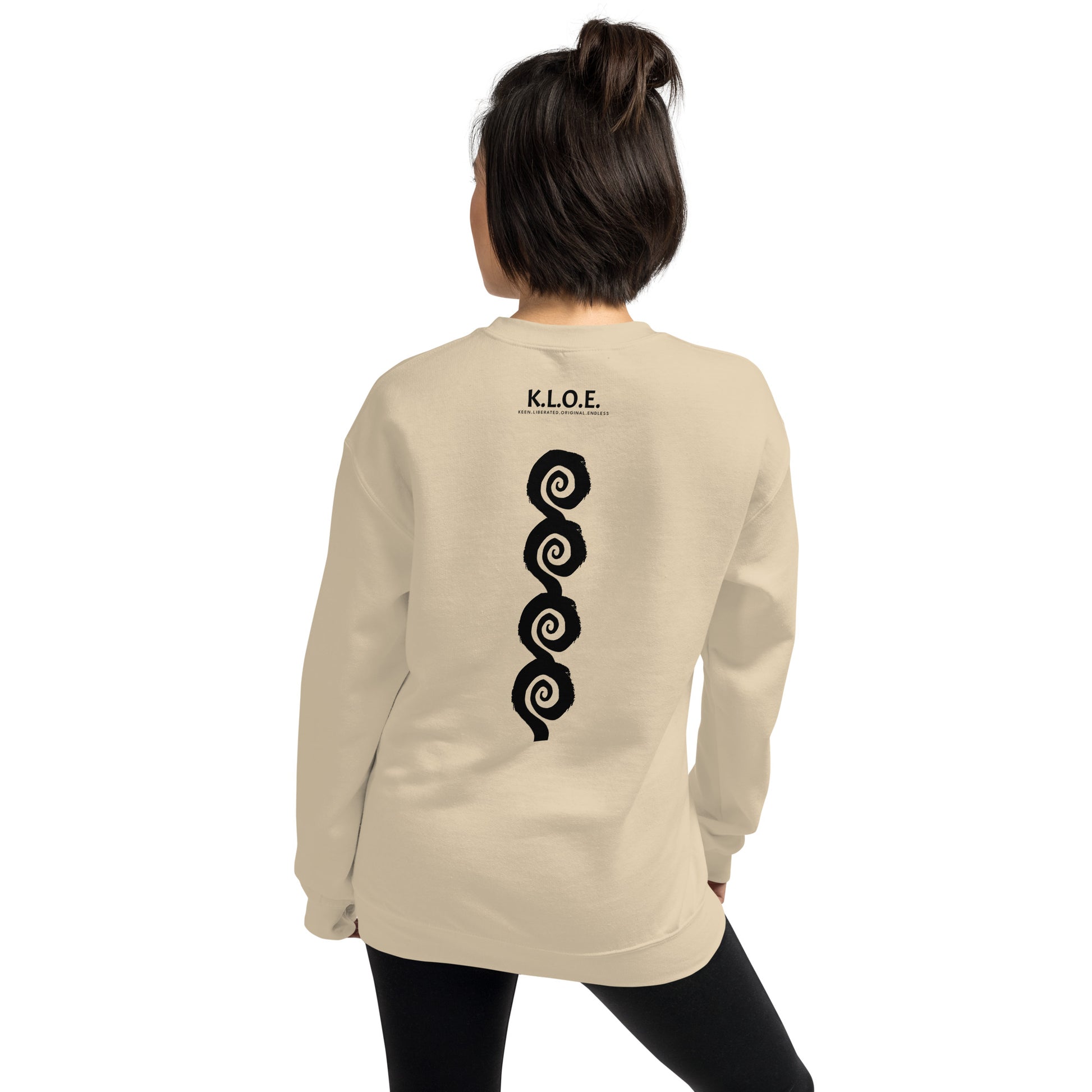 Back view of sand color K.L.O.E. sweatshirt showcasing a bold, hand-drawn black spiral design symbolising creativity and individuality, with the K.L.O.E. logo above, reflecting modern bohemian style and artistic self-expression, worn by a model.