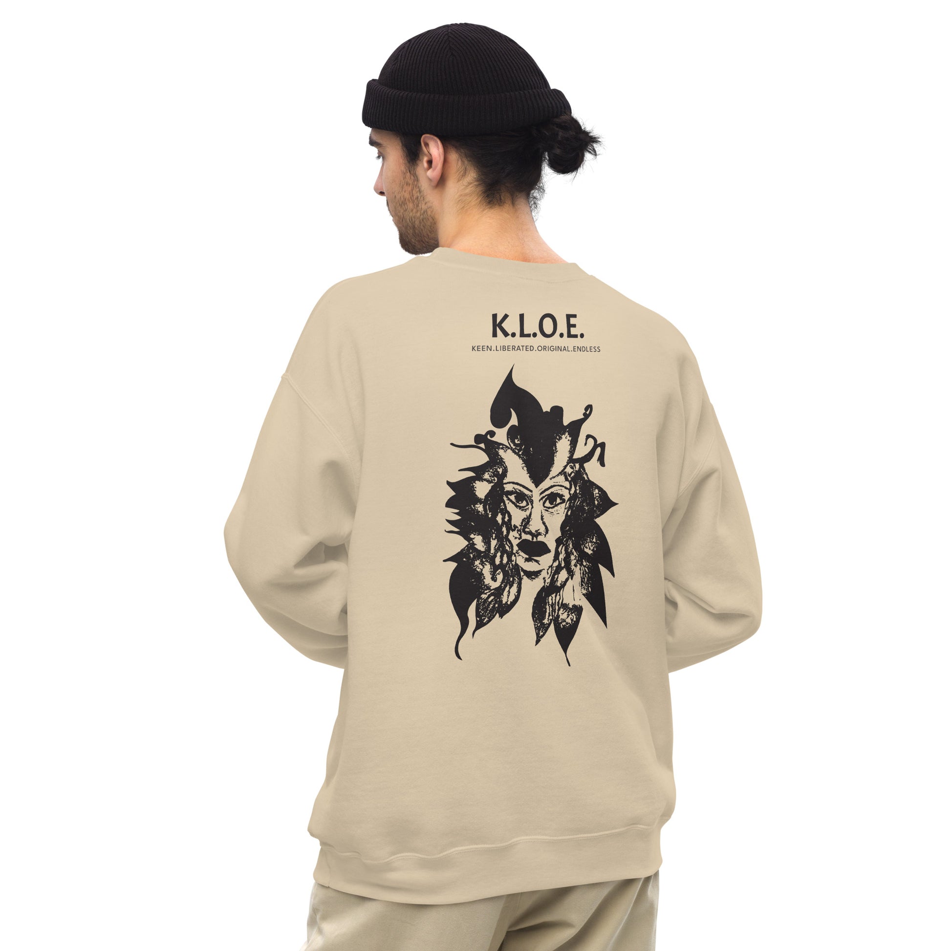 Back view of a sand K.L.O.E. sweatshirt showcasing a culturally inspired, hand-drawn black design featuring a bold, expressive face intertwined with flowing, abstract patterns, and K.L.O.E. logo, embodying artistic self-expression and modern bohemian style fashion, on a model.