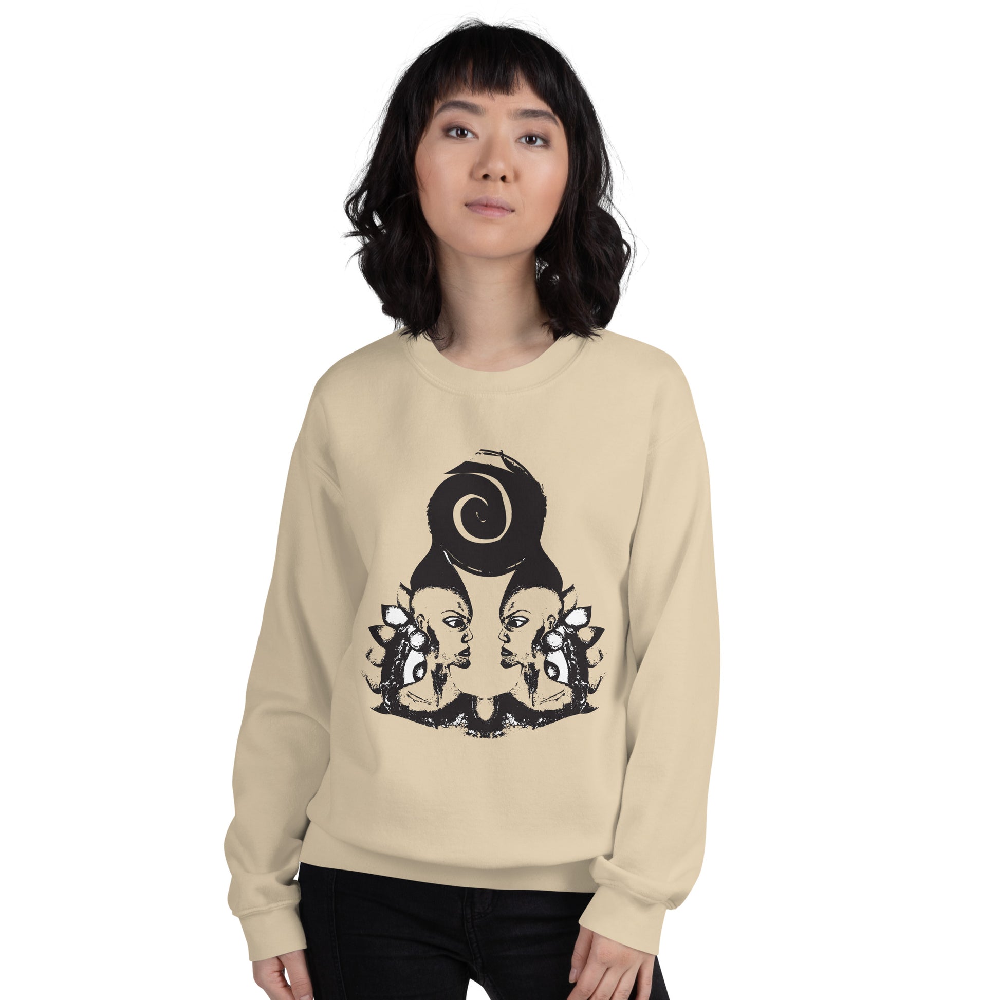A model wearing sand color K.L.O.E. sweatshirt featuring a culturally inspired, hand-drawn design of two mirrored faces in bold black, showcasing unique artistry and self-expression in modern bohemian style clothing.