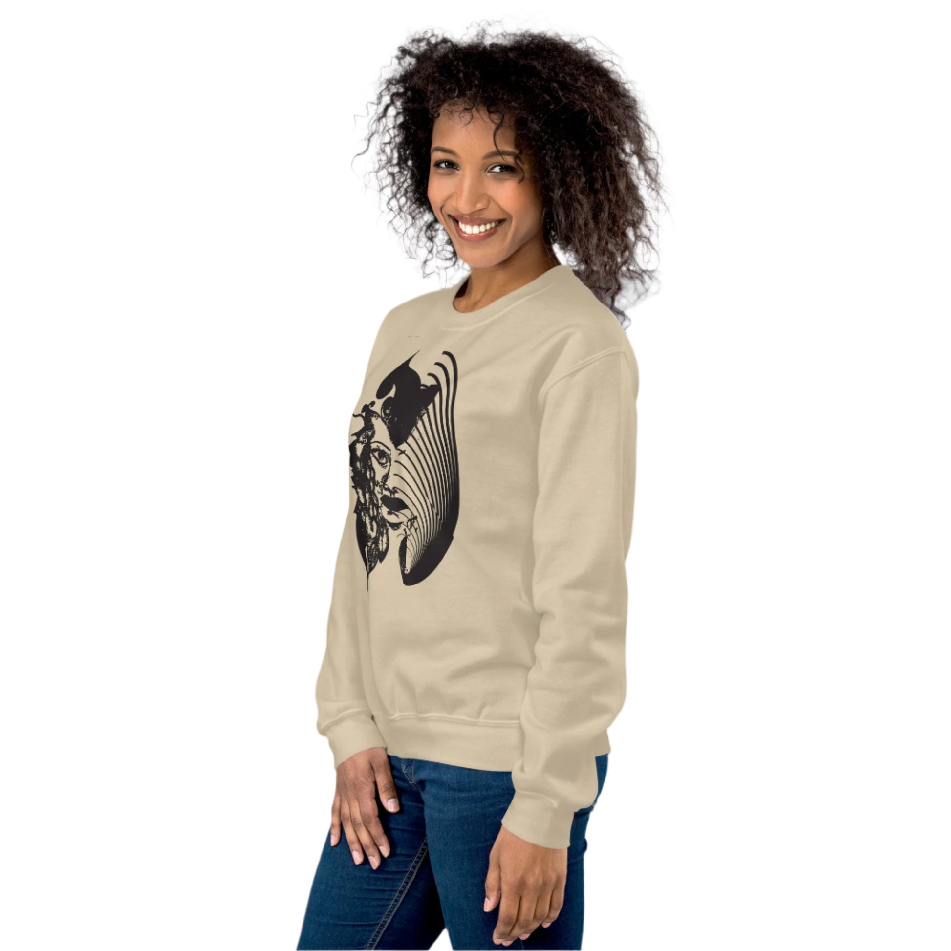  A model wearing sand K.L.O.E. sweatshirt featuring a culturally inspired, hand-drawn black graphic of a bold, expressive face surrounded by intricate details, celebrating individuality and artistic self-expression in modern bohemian style fashion.