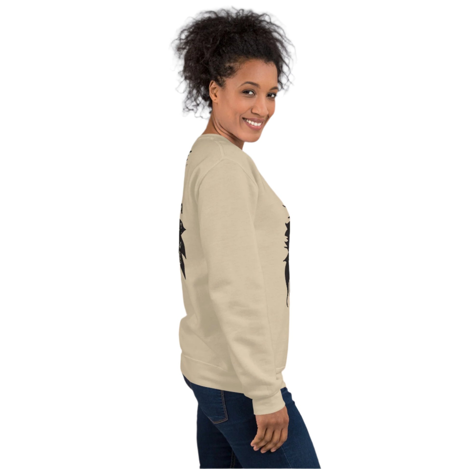  A model wearing sand K.L.O.E. sweatshirt featuring a culturally inspired, hand-drawn black graphic of a bold, expressive face surrounded by intricate details, celebrating individuality and artistic self-expression in modern bohemian style fashion.