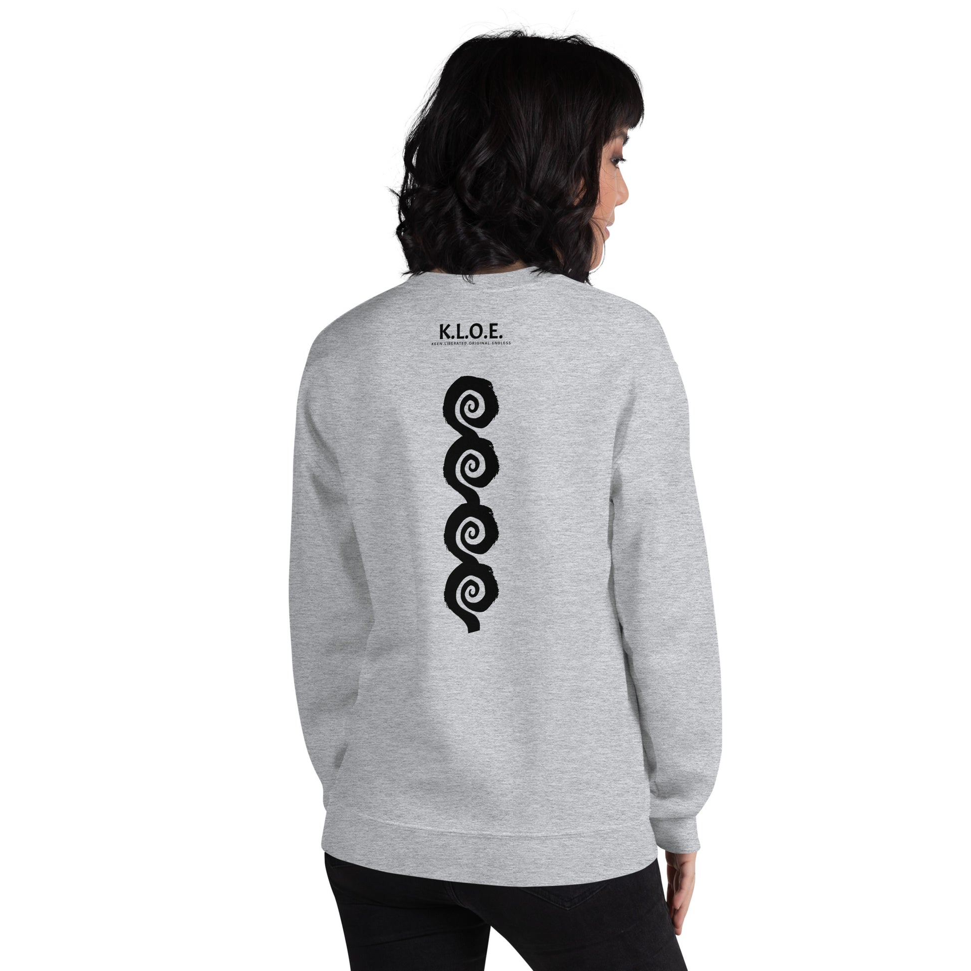 Back view of grey K.L.O.E. sweatshirt showcasing a bold, hand-drawn black spiral design symbolising creativity and individuality, with the K.L.O.E. logo above, reflecting modern bohemian style and artistic self-expression, worn by a model.