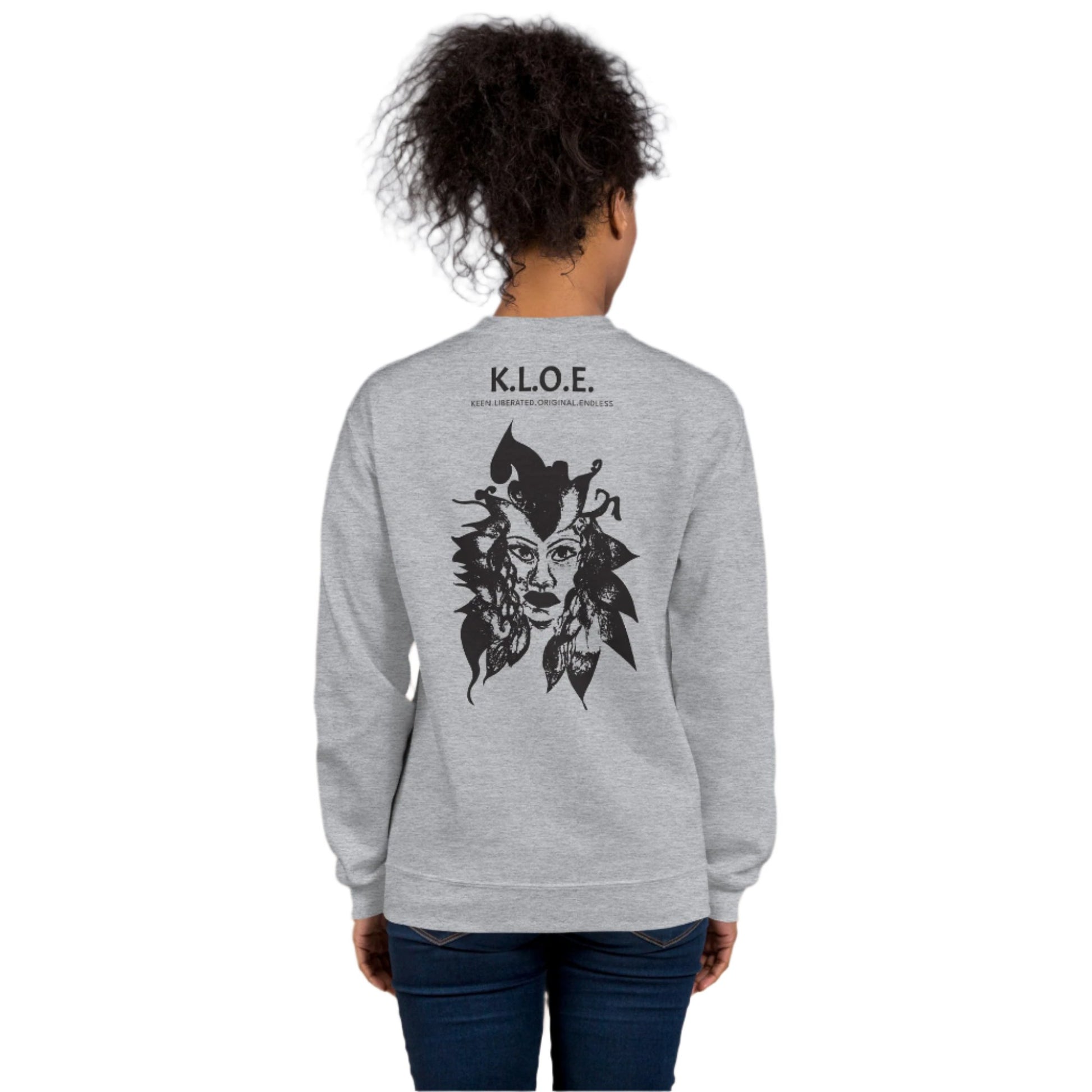 Back view of a grey K.L.O.E. sweatshirt showcasing a culturally inspired, hand-drawn black design featuring a bold, expressive face intertwined with flowing, abstract patterns, and K.L.O.E. logo, embodying artistic self-expression and modern bohemian style fashion, on a model.