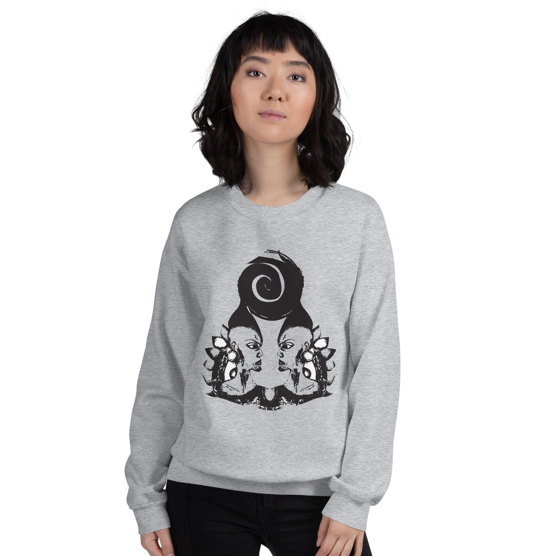 A model wearing grey K.L.O.E. sweatshirt featuring a culturally inspired, hand-drawn design of two mirrored faces in bold black, showcasing unique artistry and self-expression in modern bohemian style clothing.