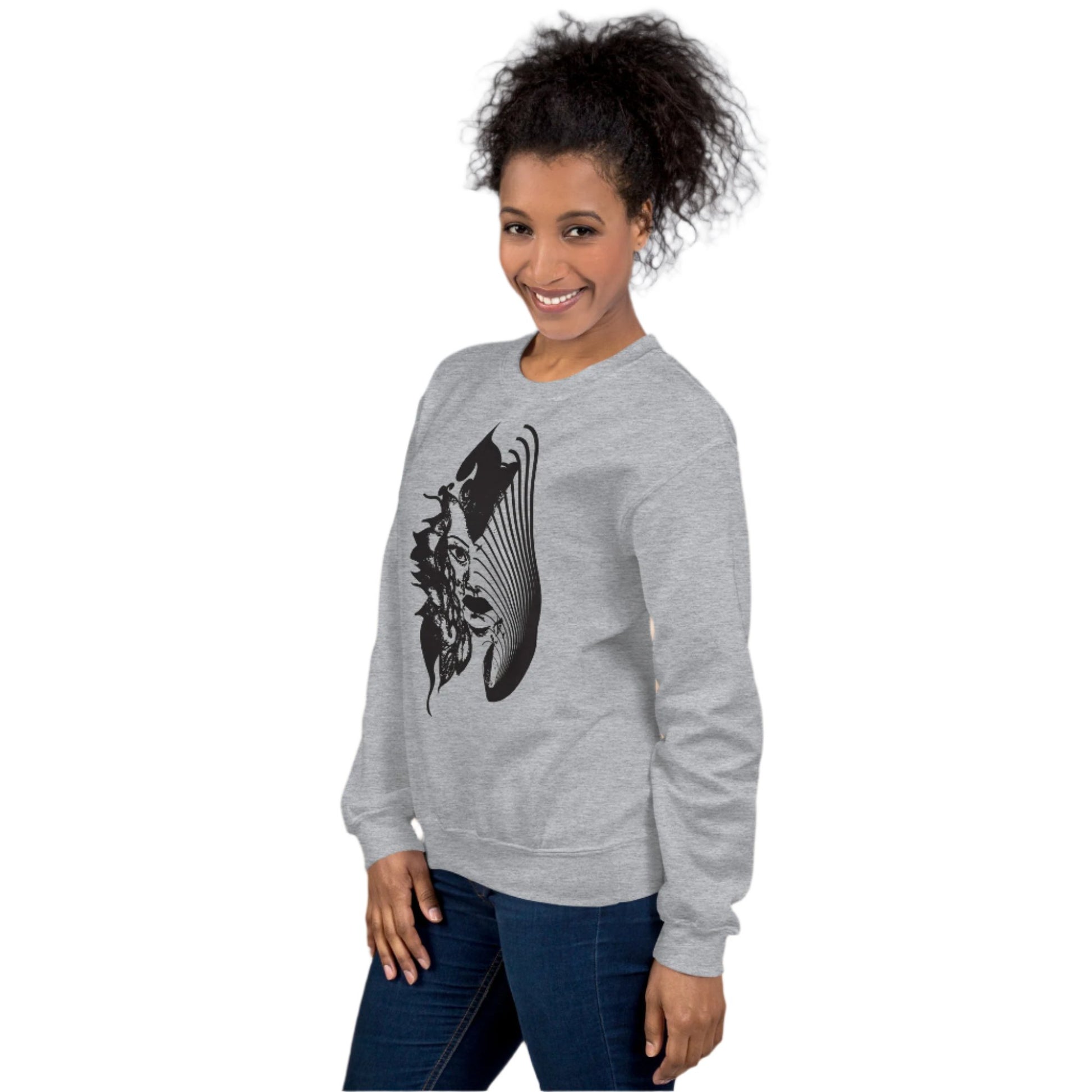 A model wearing grey K.L.O.E. sweatshirt featuring a culturally inspired, hand-drawn black graphic of a bold, expressive face surrounded by intricate details, celebrating individuality and artistic self-expression in modern bohemian style fashion.