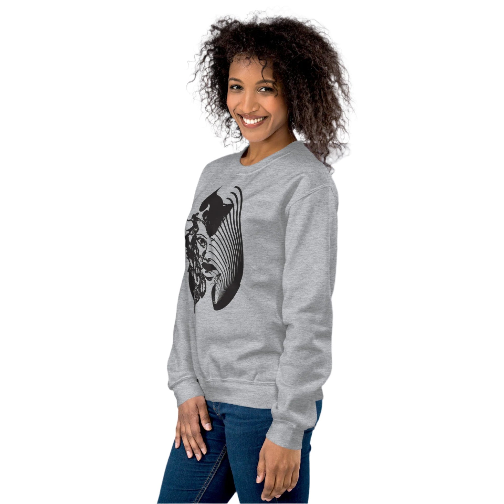 A model wearing grey K.L.O.E. sweatshirt featuring a culturally inspired, hand-drawn black graphic of a bold, expressive face surrounded by intricate details, celebrating individuality and artistic self-expression in modern bohemian style fashion.