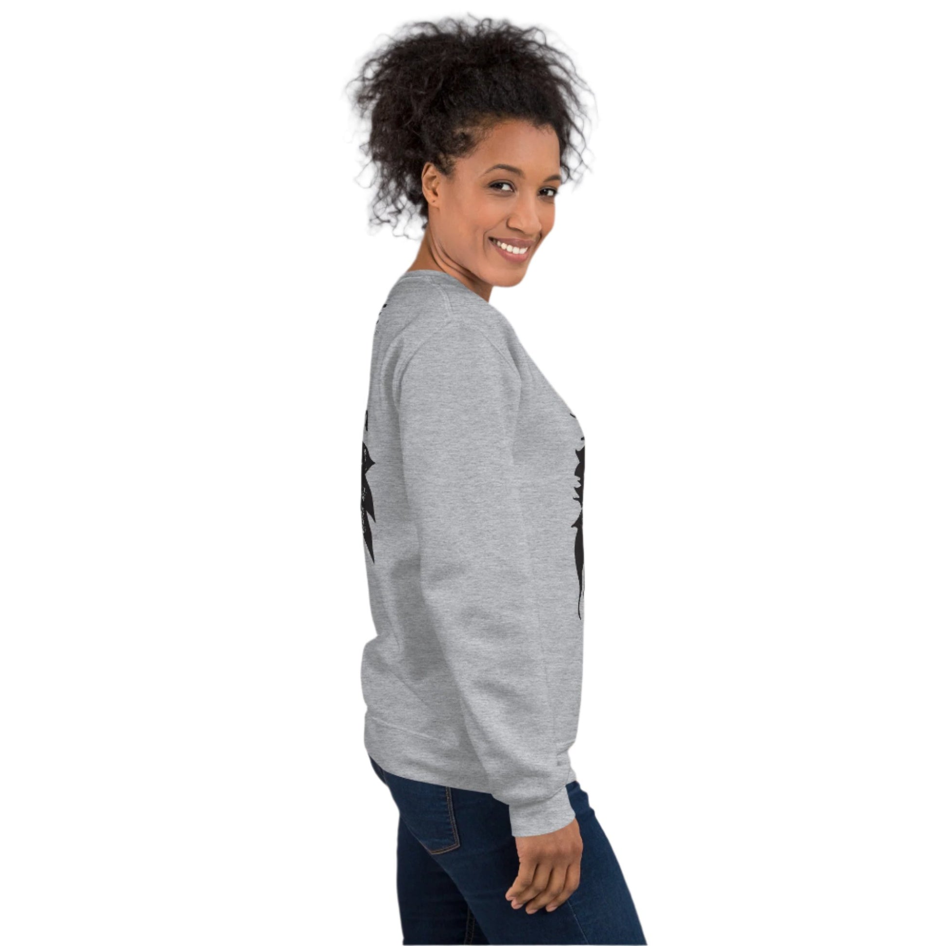 A model wearing grey K.L.O.E. sweatshirt featuring a culturally inspired, hand-drawn black graphic of a bold, expressive face surrounded by intricate details, celebrating individuality and artistic self-expression in modern bohemian style fashion.