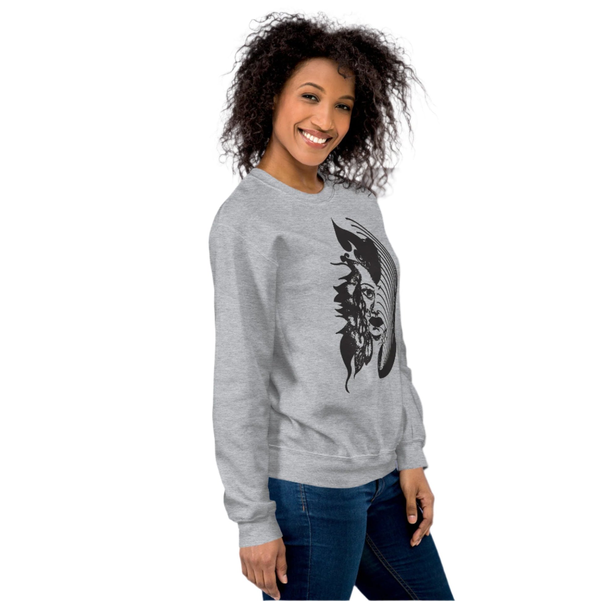 A model wearing grey K.L.O.E. sweatshirt featuring a culturally inspired, hand-drawn black graphic of a bold, expressive face surrounded by intricate details, celebrating individuality and artistic self-expression in modern bohemian style fashion.