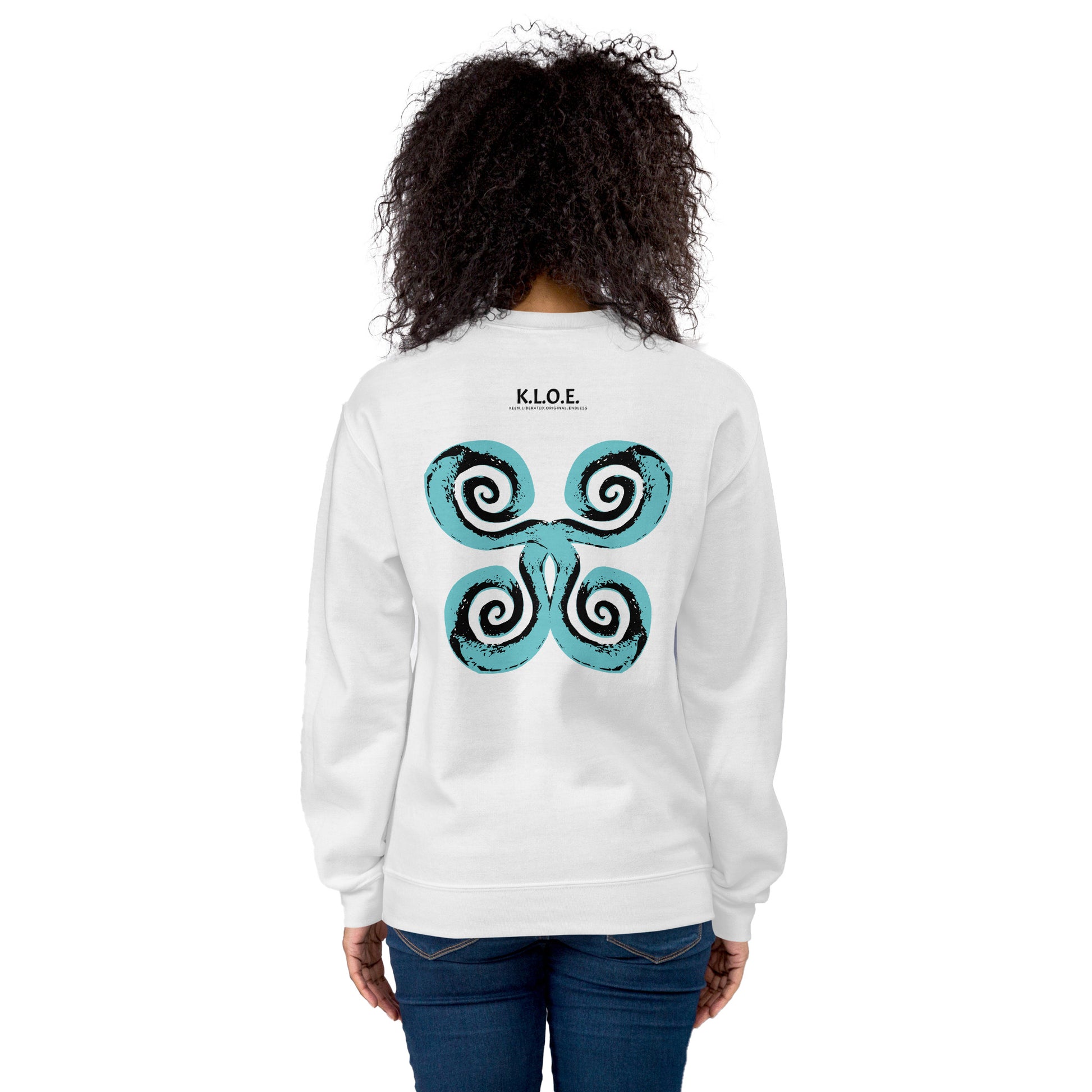 The back of the white K.L.O.E. sweatshirt featuring a culturally inspired, hand-drawn design of bold black and teal spirals, symbolizing self-expression, individuality, and modern bohemian style, worn by a model.