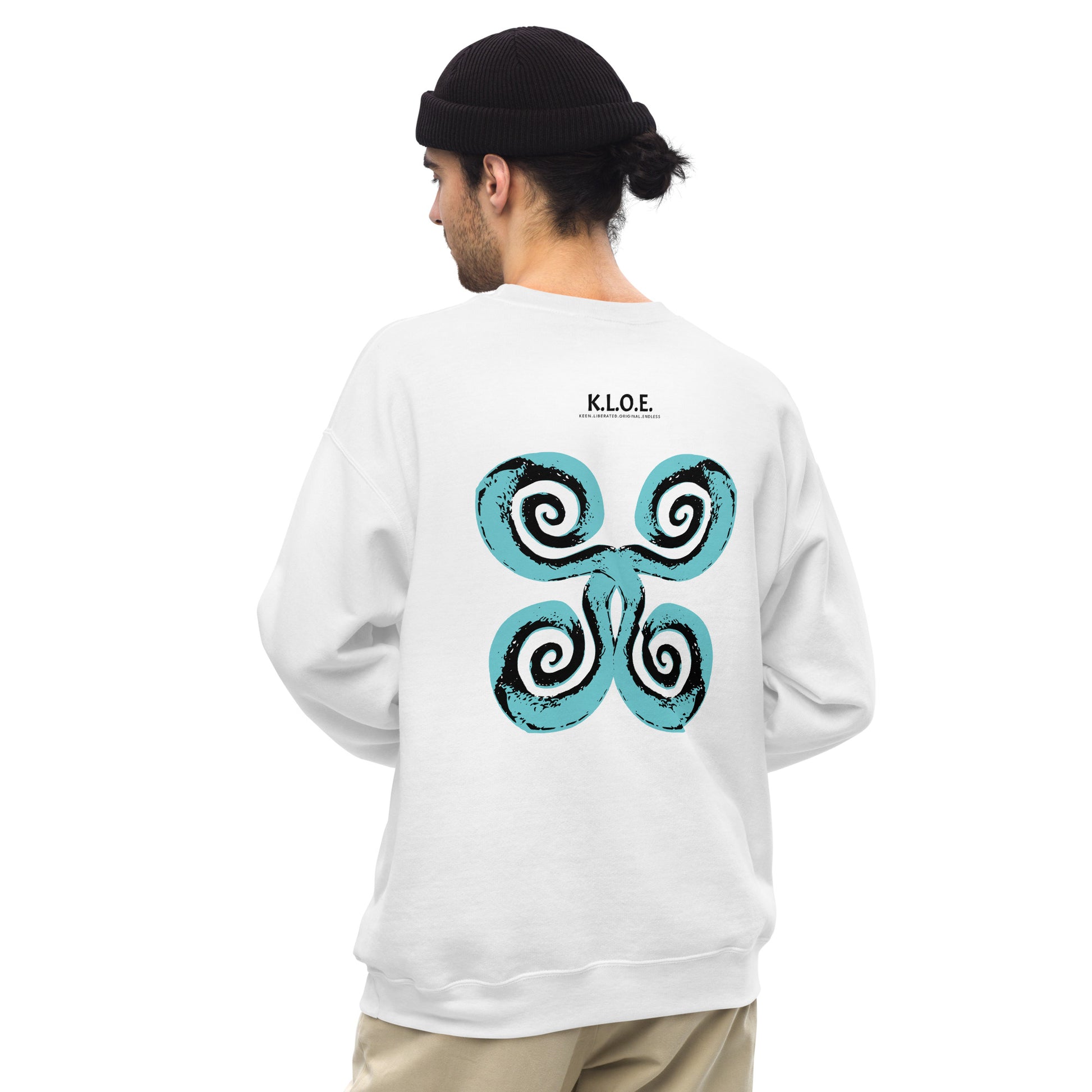 The back of the white K.L.O.E. sweatshirt featuring a culturally inspired, hand-drawn design of bold black and teal spirals, symbolizing self-expression, individuality, and modern bohemian style, worn by a male model.