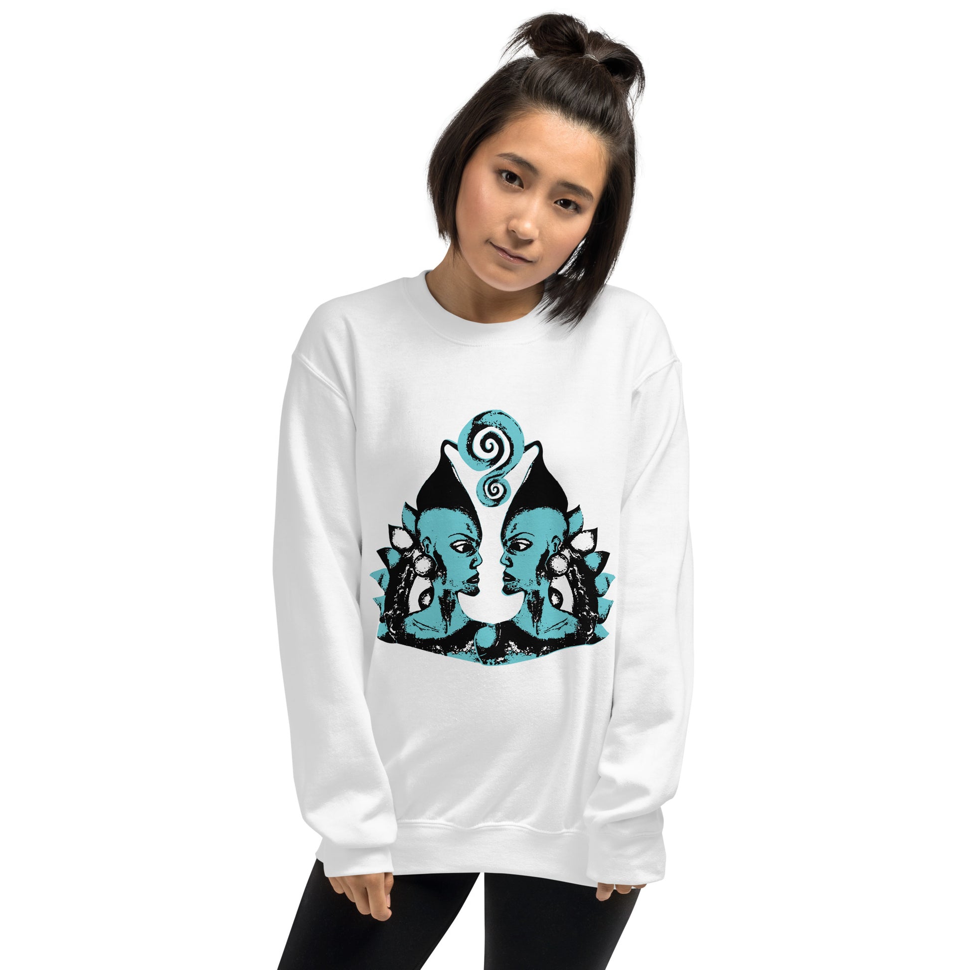 A model wearing the white K.L.O.E. sweatshirt featuring a hand-drawn design of two mirrored faces in bold black and teal, showcasing cultural inspiration, individuality, and modern bohemian style self-expression.