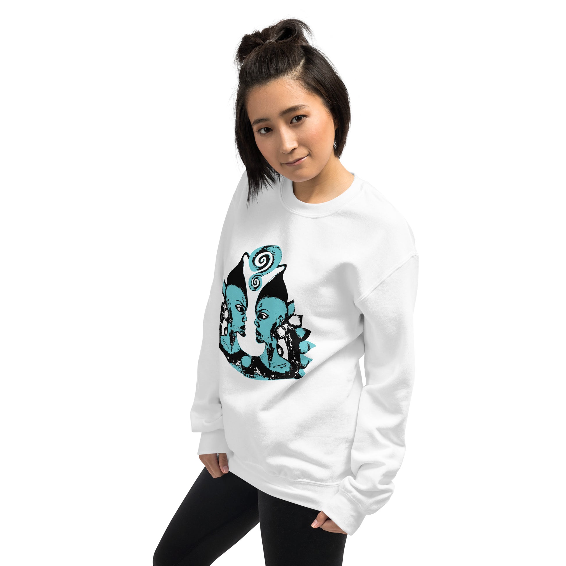 A model wearing the white K.L.O.E. sweatshirt featuring a hand-drawn design of two mirrored faces in bold black and teal, showcasing cultural inspiration, individuality, and modern bohemian style self-expression.