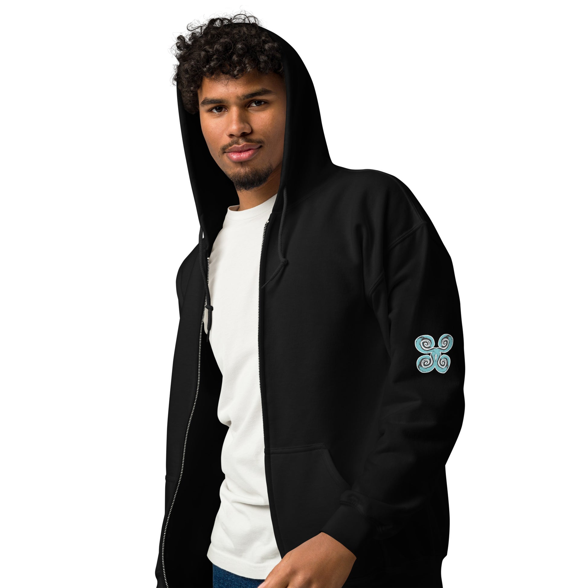 The model wearing black zip-up hoodie featuring a striking, hand-drawn graphic on the back of two mirrored female figures with intricate headpieces in black and teal, connected by a central spiral element, on the back. Teal spiral accents appear on each sleeve, adding a touch of cultural artistry. This K.L.O.E. design embodies modern boho style and expressive, artisan-crafted fashion, ideal for those who embrace unique, eco-friendly apparel and global inspiration.