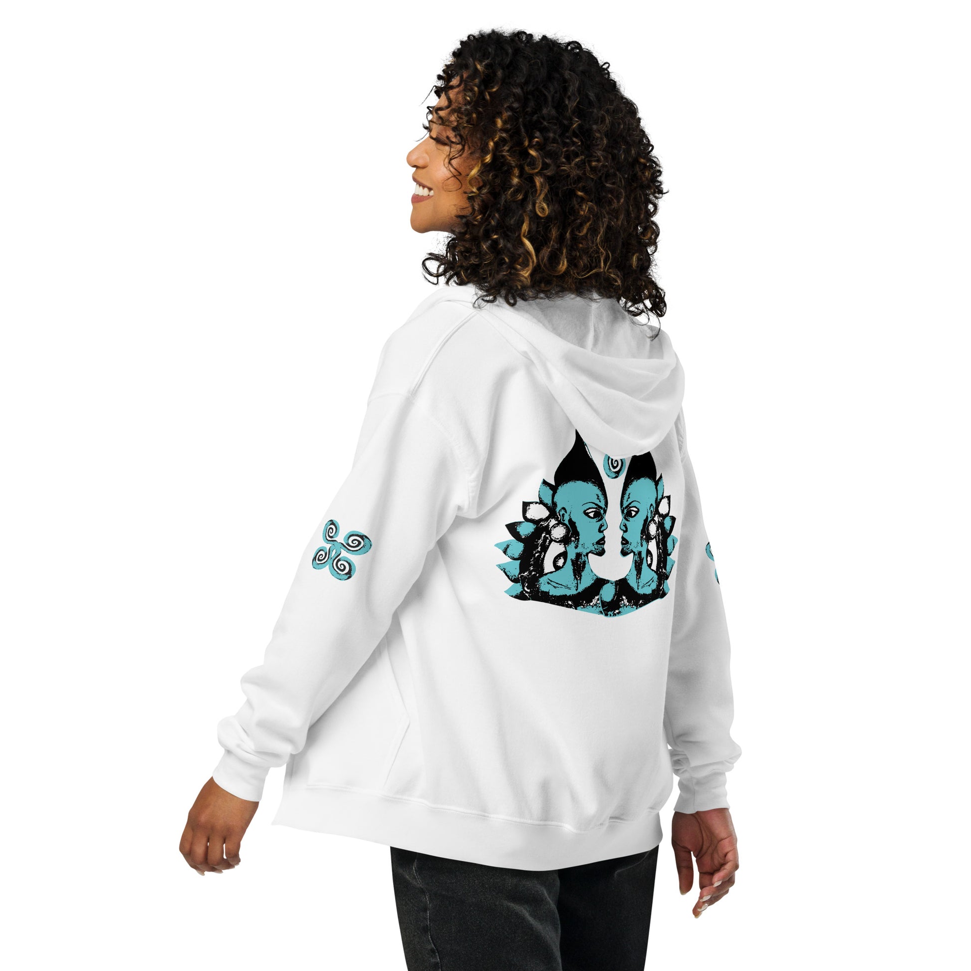 White zip-up hoodie featuring a striking, hand-drawn graphic on the back of two mirrored female figures with intricate headpieces in black and teal, connected by a central spiral element. Teal spiral accents appear on each sleeve, adding a touch of cultural artistry. This K.L.O.E. design embodies modern boho style and expressive, artisan-crafted fashion, ideal for those who embrace unique, eco-friendly apparel and global inspiration, worn by model.