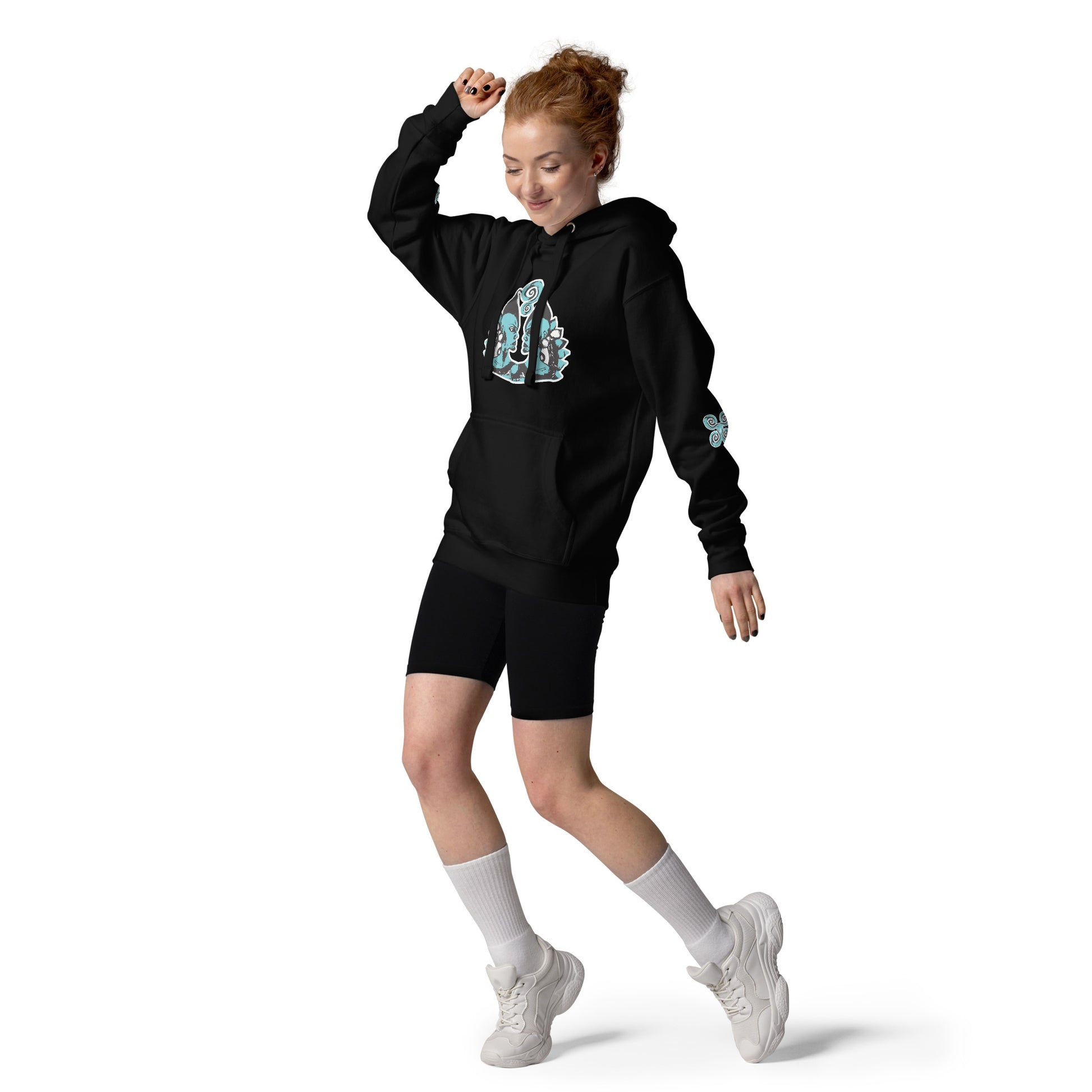 Front of black K.L.O.E. hoodie featuring a hand-drawn design of two mirrored faces in teal and white, highlighting culturally inspired, bohemian style fashion with a focus on individuality, artistic expression, and modern eco-friendly fashion, worn by a model.