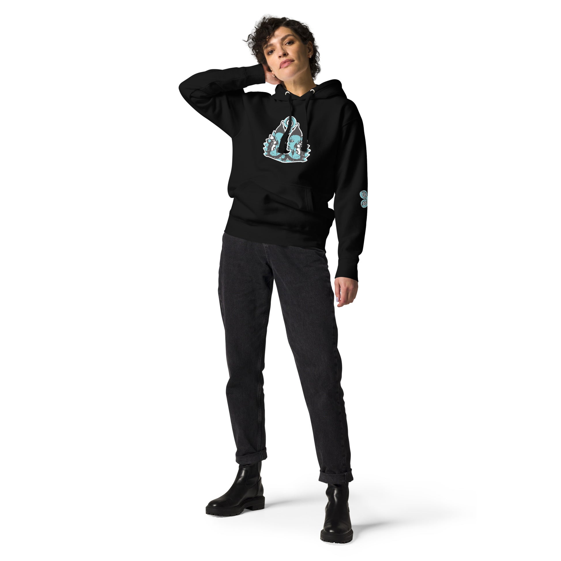 Front of black K.L.O.E. hoodie featuring a hand-drawn design of two mirrored faces in teal and white, highlighting culturally inspired, bohemian style fashion with a focus on individuality, artistic expression, and modern eco-friendly fashion, worn by a model.