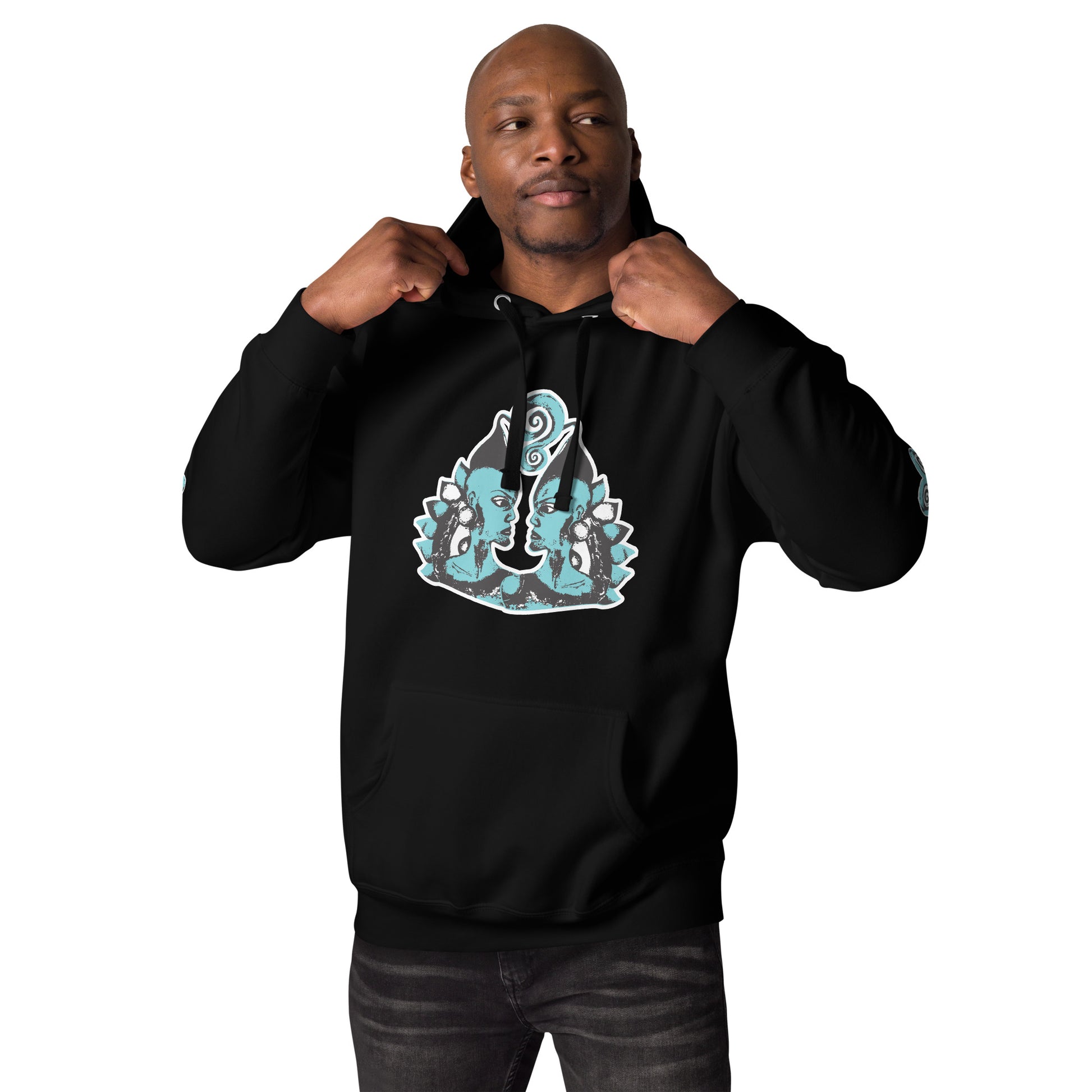 Front of black K.L.O.E. hoodie featuring a hand-drawn design of two mirrored faces in teal and white, highlighting culturally inspired, bohemian style fashion with a focus on individuality, artistic expression, and modern eco-friendly fashion, worn by a male model.