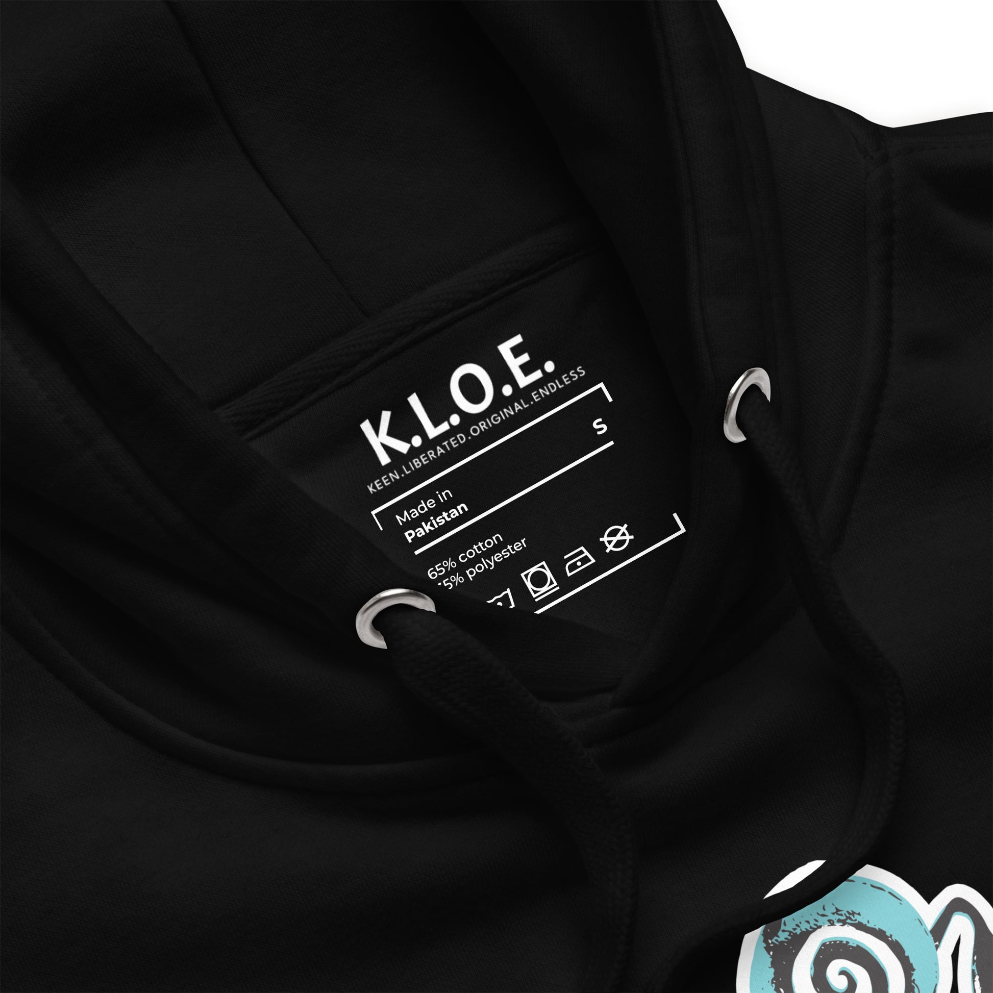 Inside label view of black K.L.O.E. hoodie featuring a hand-drawn design of two mirrored faces in teal and white, highlighting culturally inspired, bohemian style fashion with a focus on individuality, artistic expression, and modern eco-friendly fashion.
