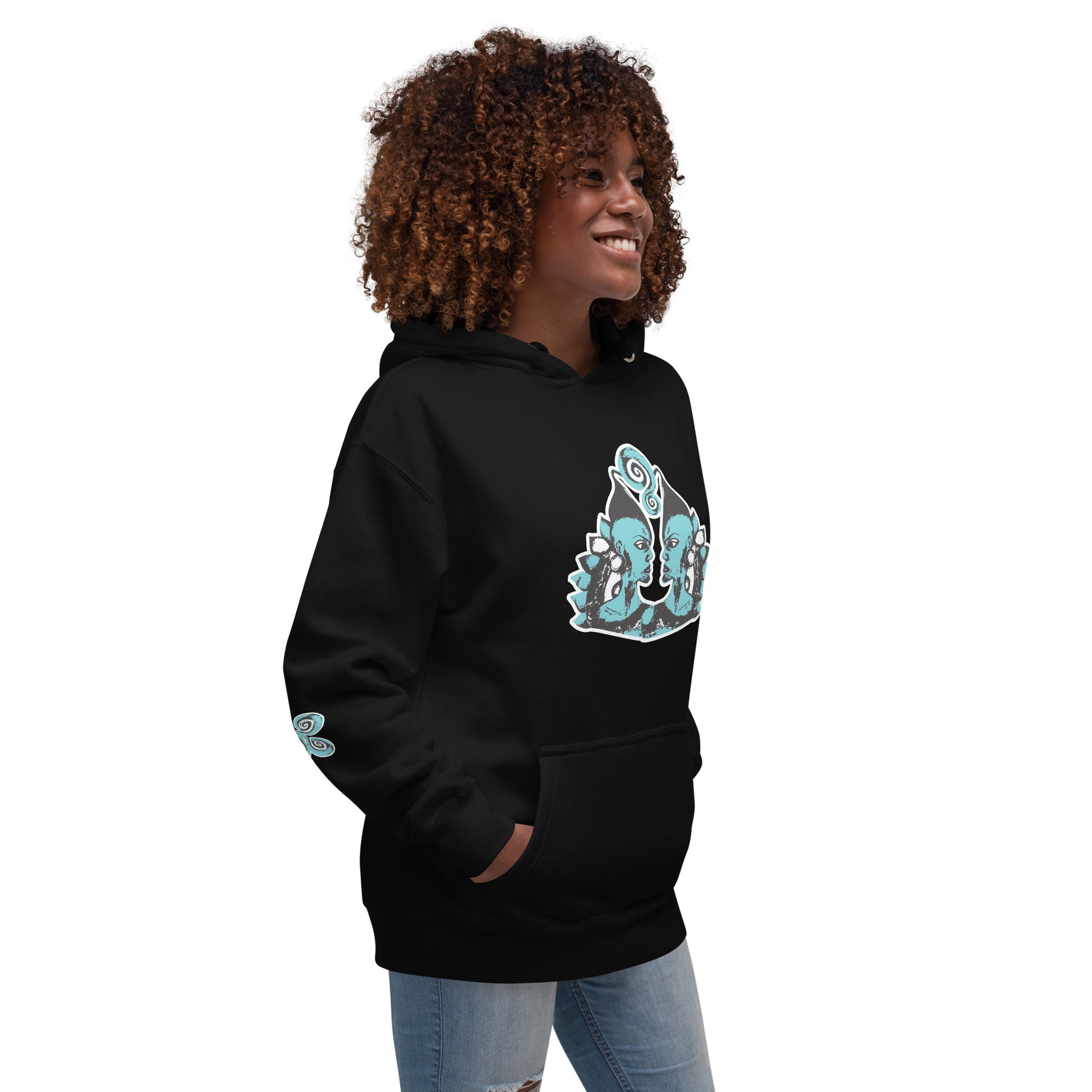 Front of black K.L.O.E. hoodie featuring a hand-drawn design of two mirrored faces in teal and white, highlighting culturally inspired, bohemian style fashion with a focus on individuality, artistic expression, and modern eco-friendly fashion, worn by a model.